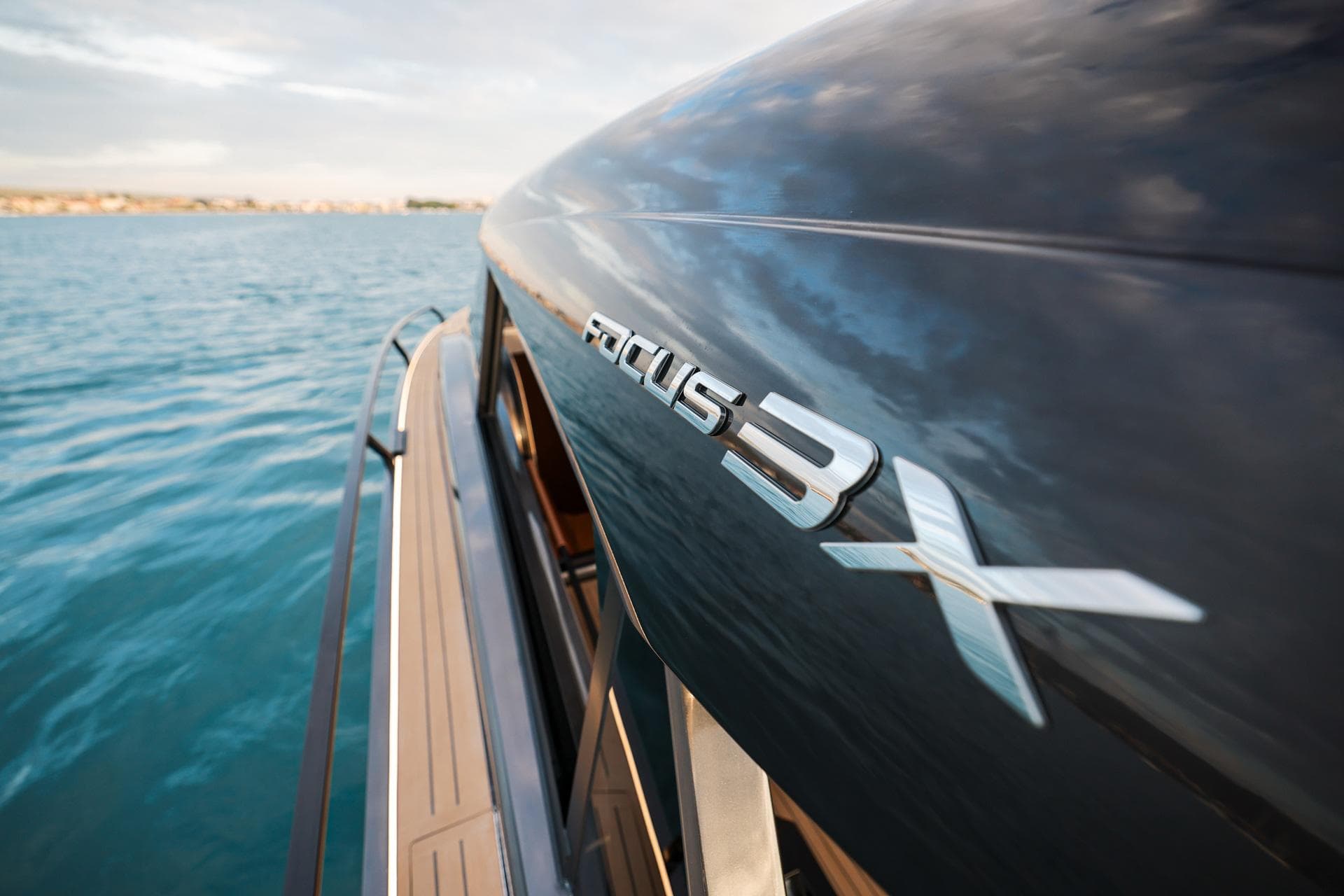 2025 Focus 3X yacht on serene blue water, showcasing sleek design.