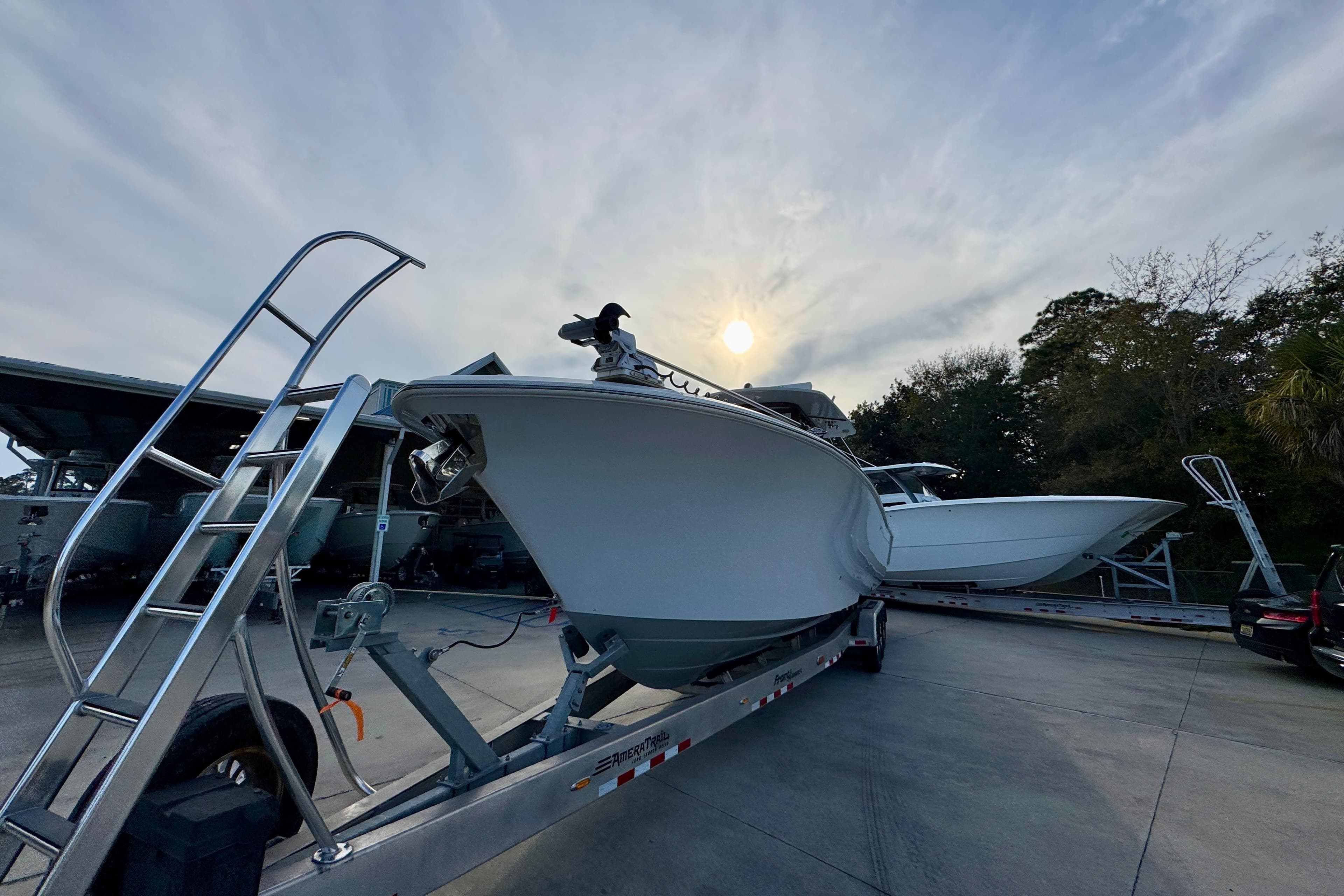 2023 Front Runner 36 Center Console boat on trailer under cloudy sky.