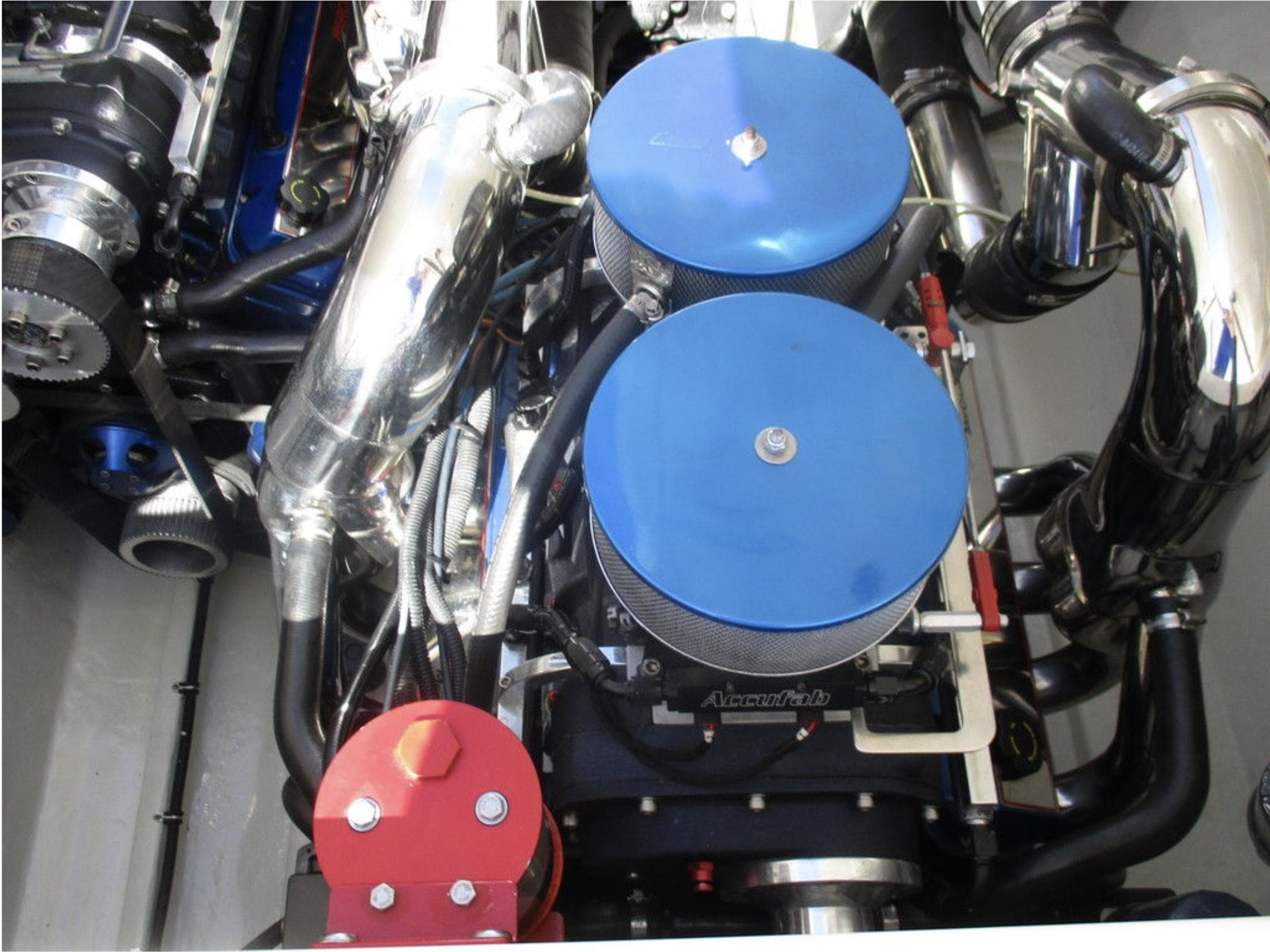 2003 Fountain 38 Lightning engine with dual blue air filters and chrome components.
