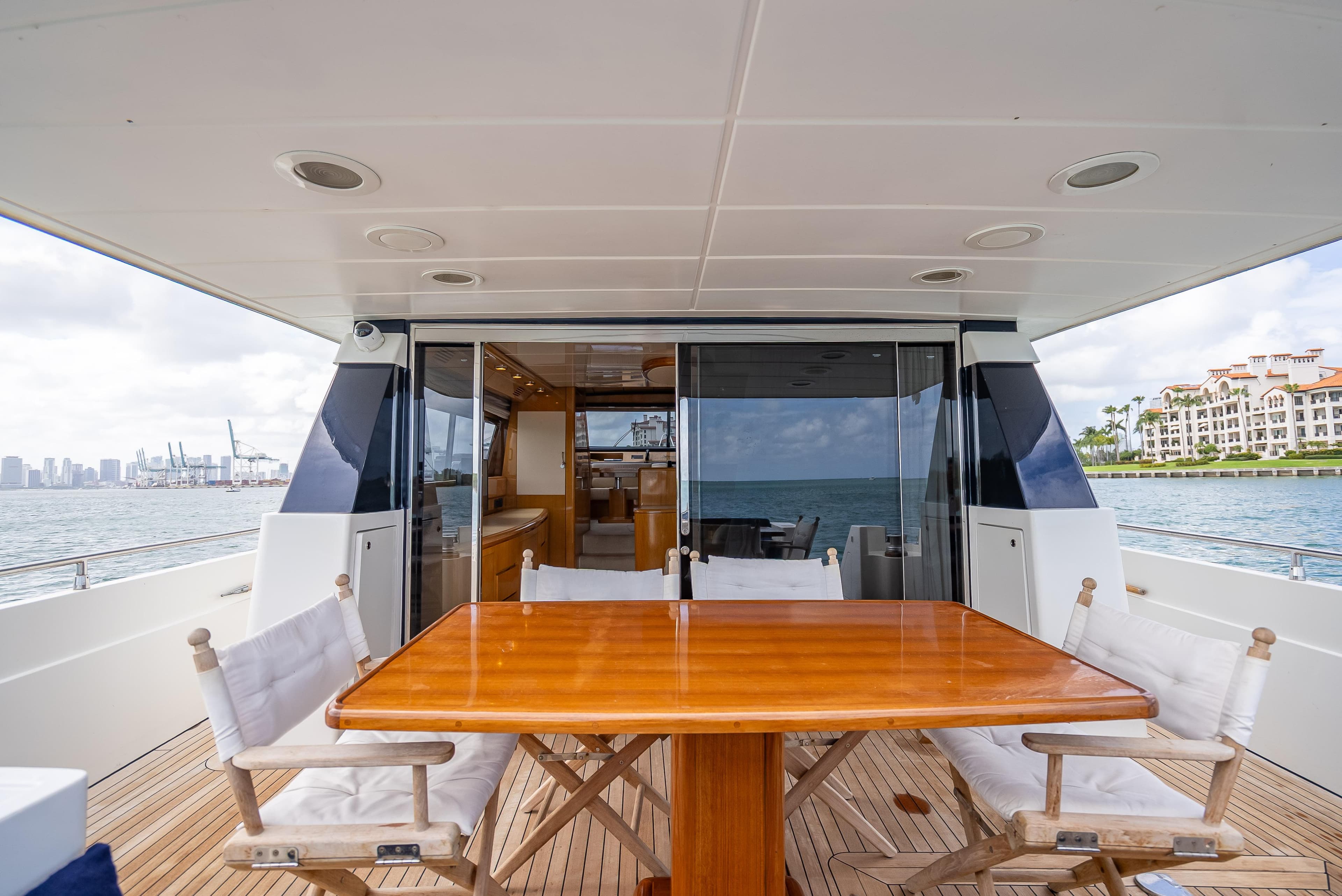Outdoor dining area on a 1995 Sanlorenzo 62 yacht with ocean view.