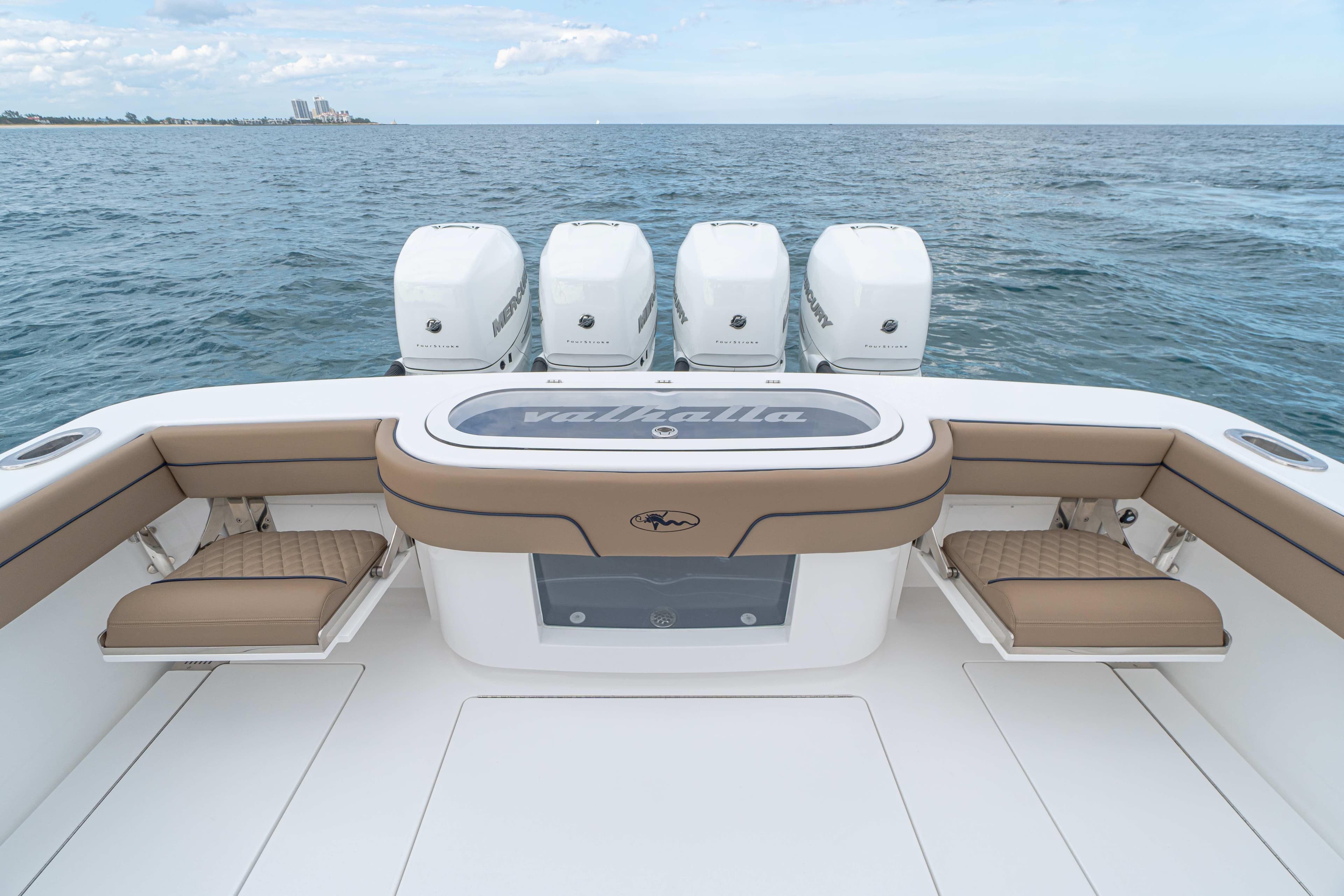 2026 Valhalla Boatworks V-41 with quad Mercury engines, featuring spacious seating and ocean backdrop.