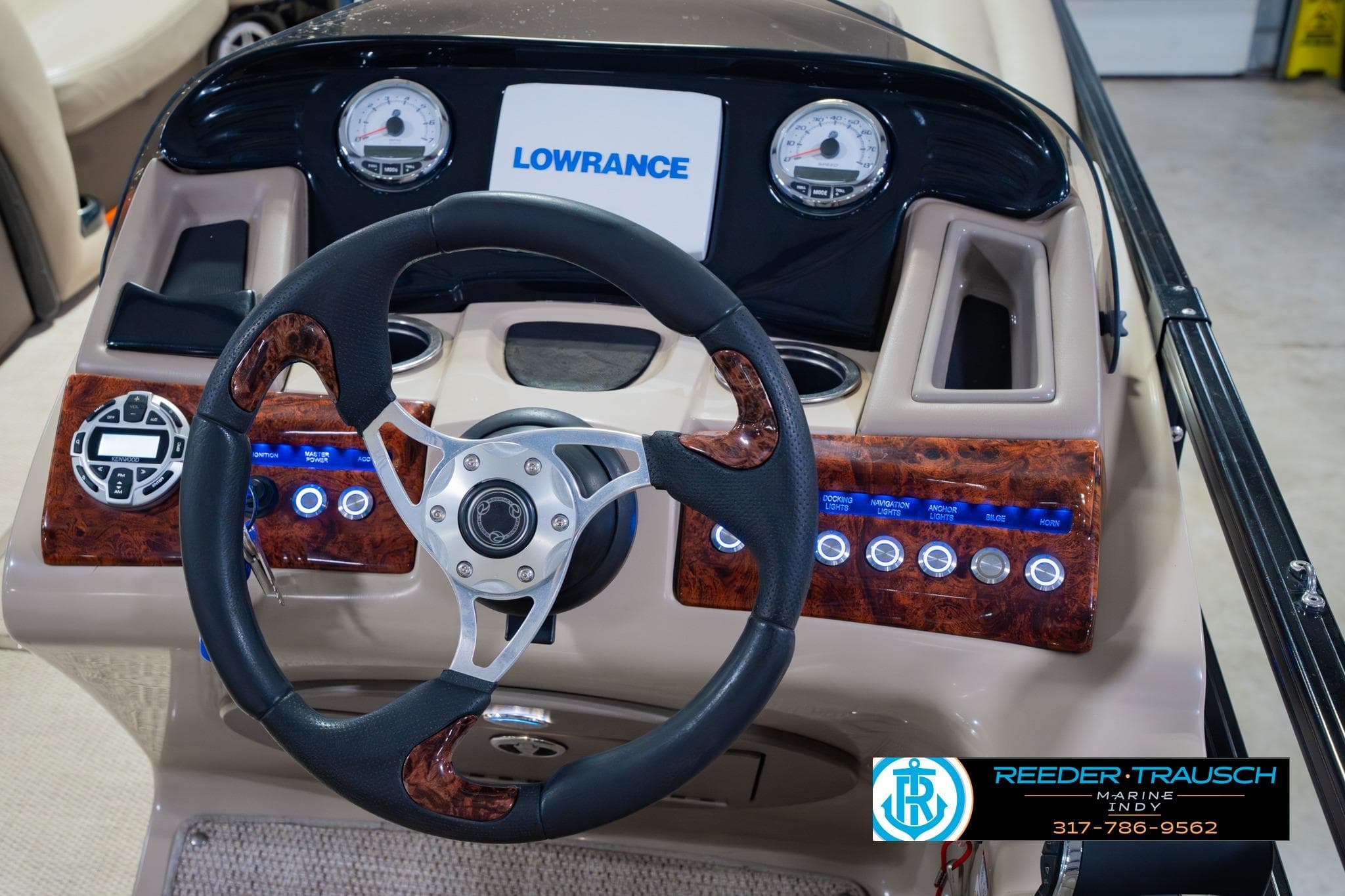 2018 Regency 254 DL3 boat dashboard with steering wheel and Lowrance display.