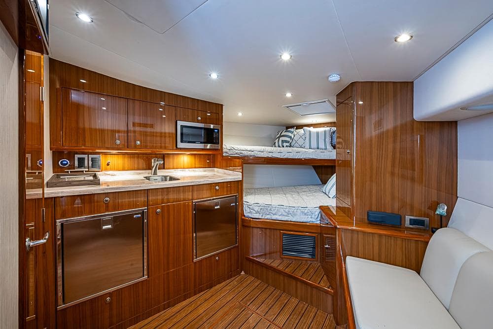 Luxurious interior of 2021 Viking 38 Open yacht with modern kitchen and cozy sleeping area.