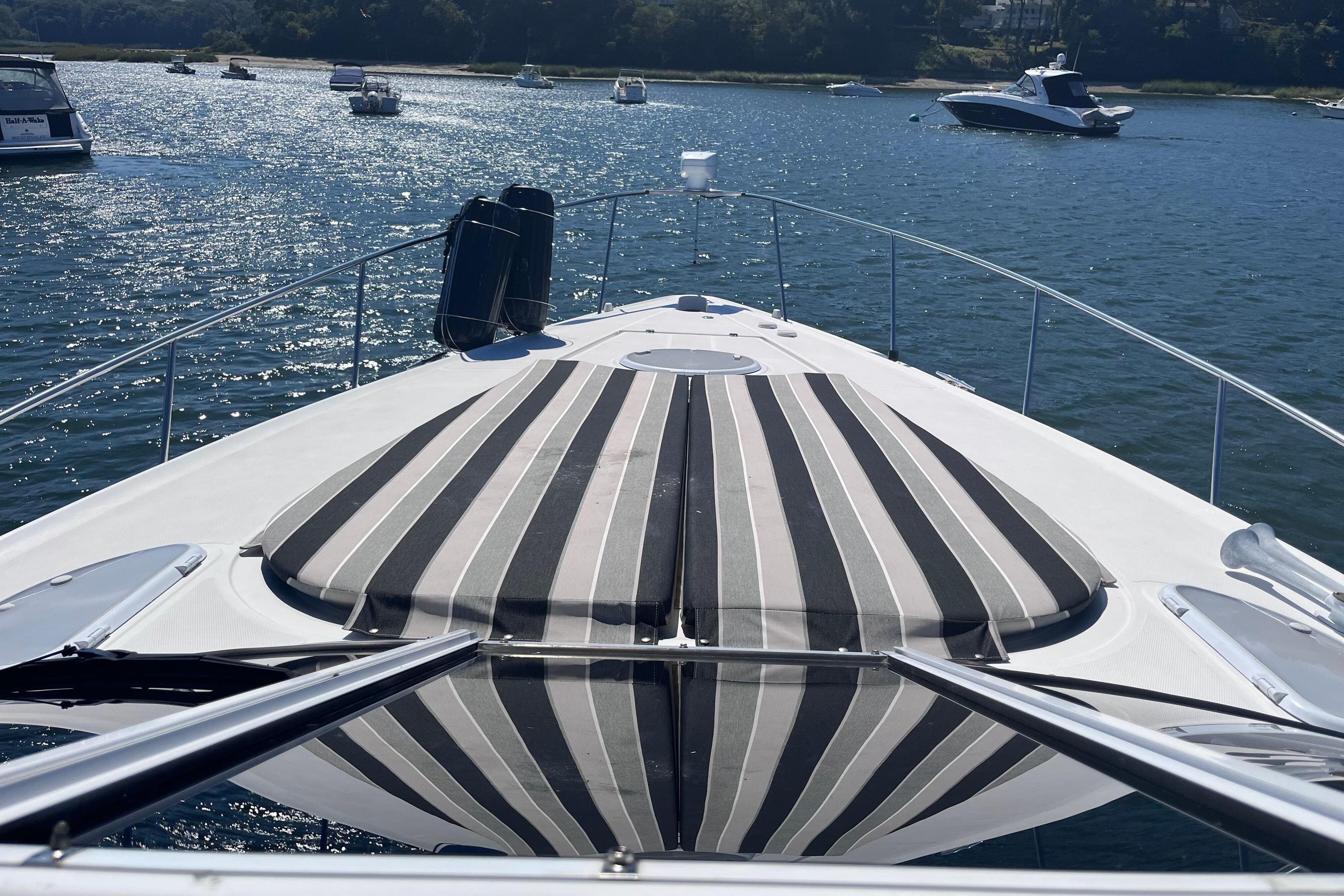 2007 Cruisers Yachts 370 Express on water, featuring striped deck cushions.