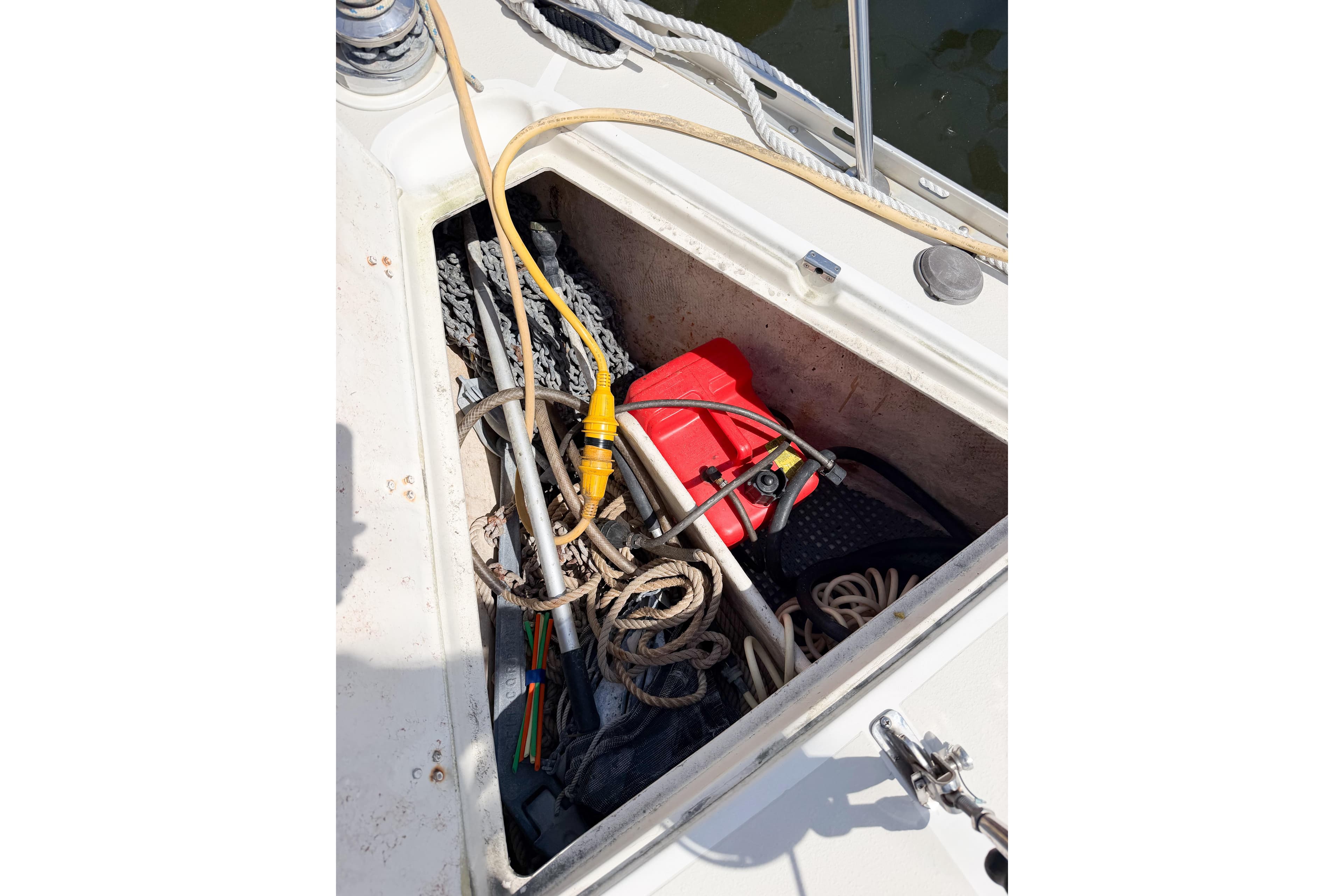 Open storage compartment on 2001 Caliber 40LRC boat with ropes and equipment.
