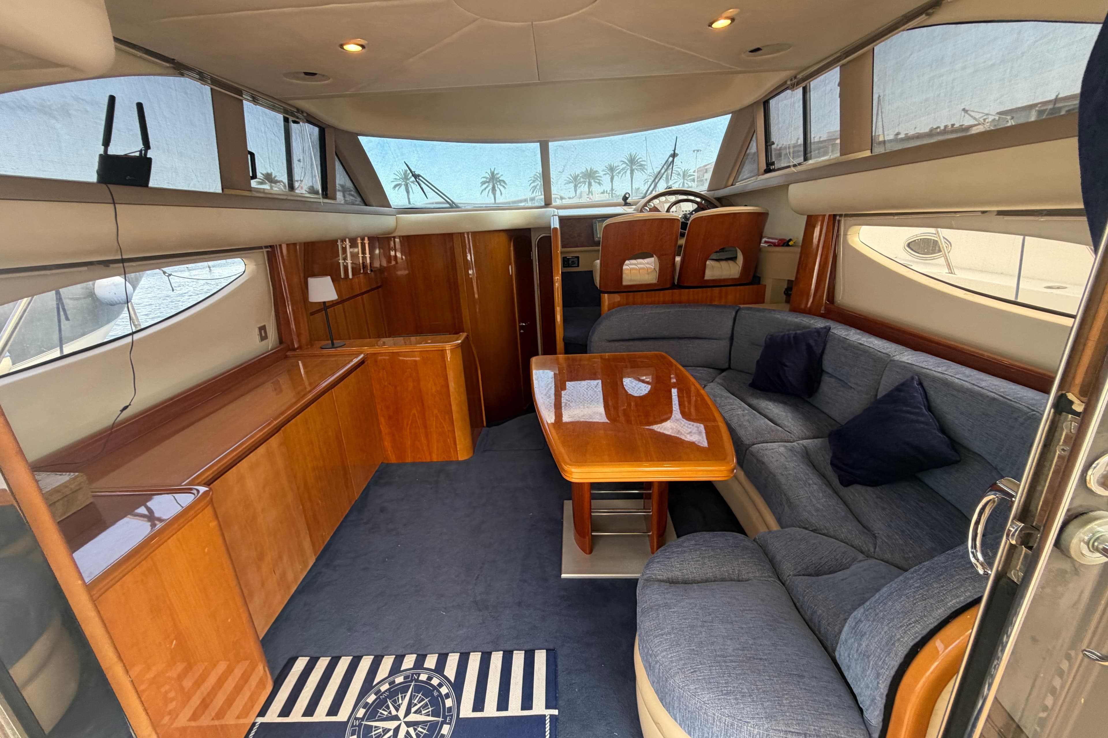 Luxurious interior of a 2000 Princess 38 yacht with elegant wood finishes and plush seating.