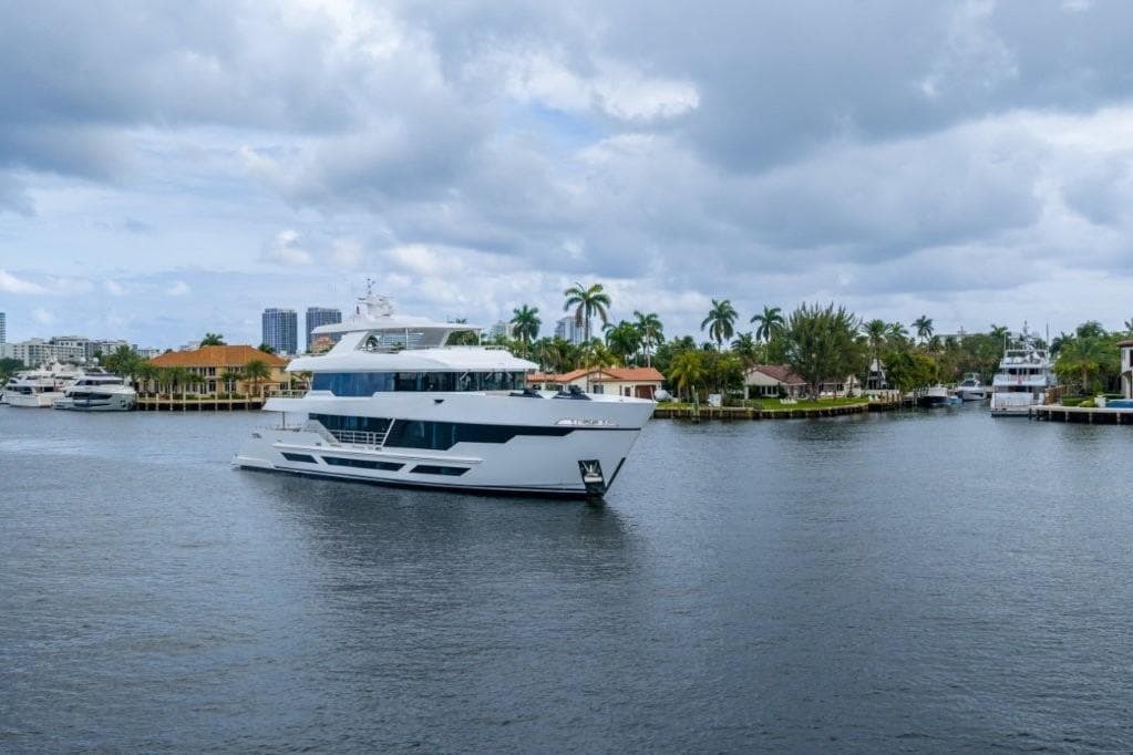 Luxurious 2026 Hargrave E Series yacht cruising in a scenic waterfront setting.