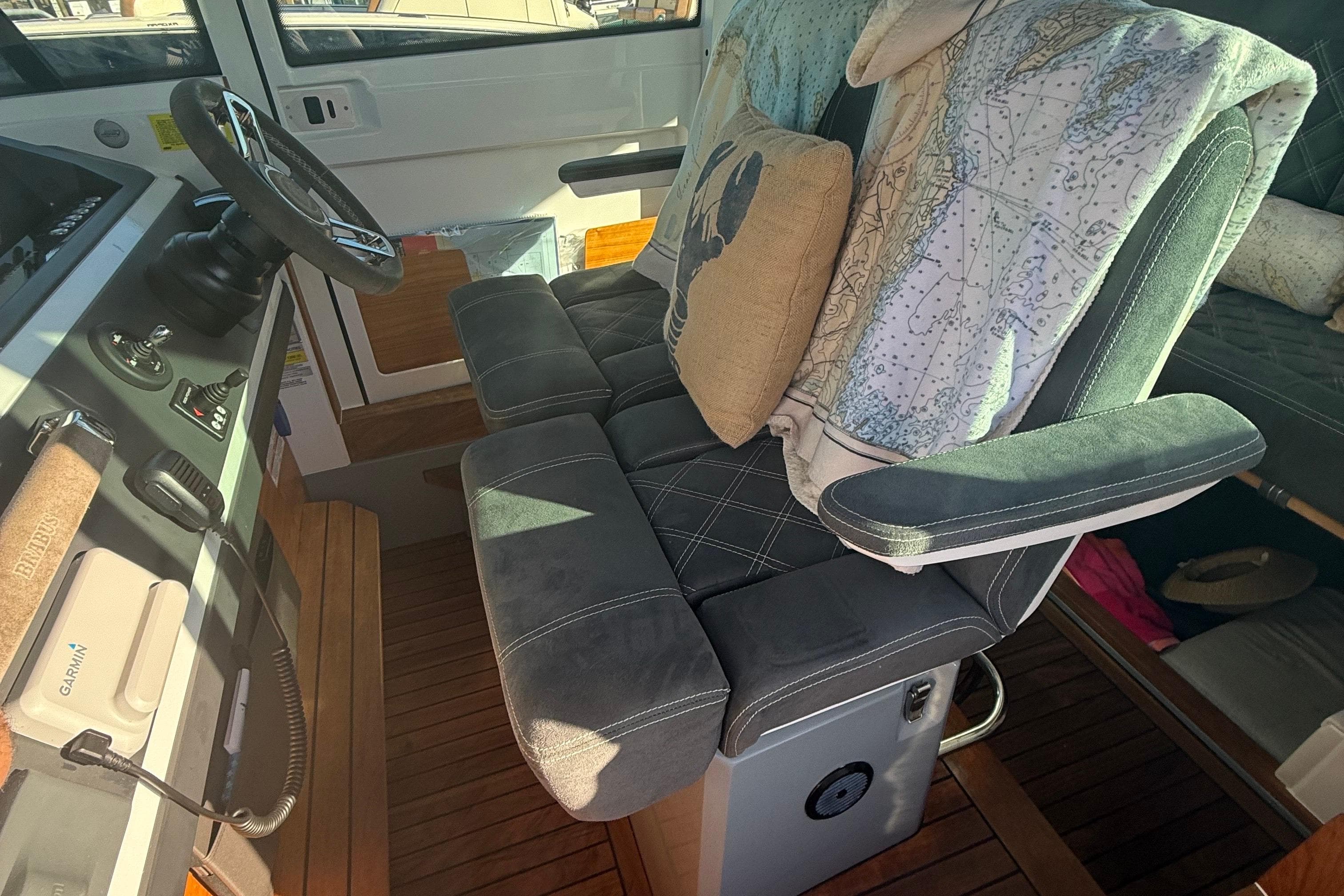Interior of 2019 Axopar 28 CABIN with plush seating and nautical decor.