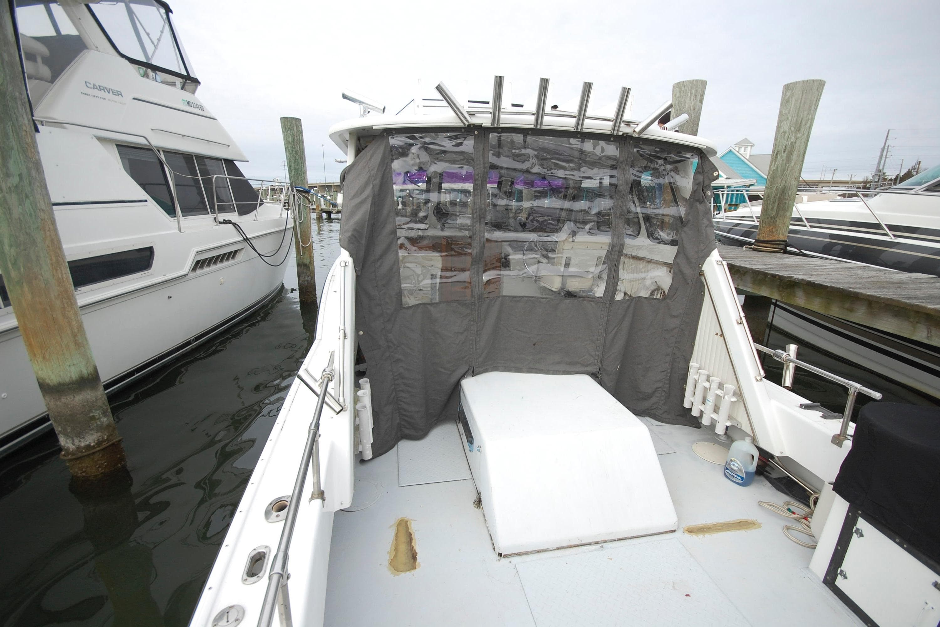 Custom Stan Haven 30 boat docked, featuring covered cockpit, 1998 model.