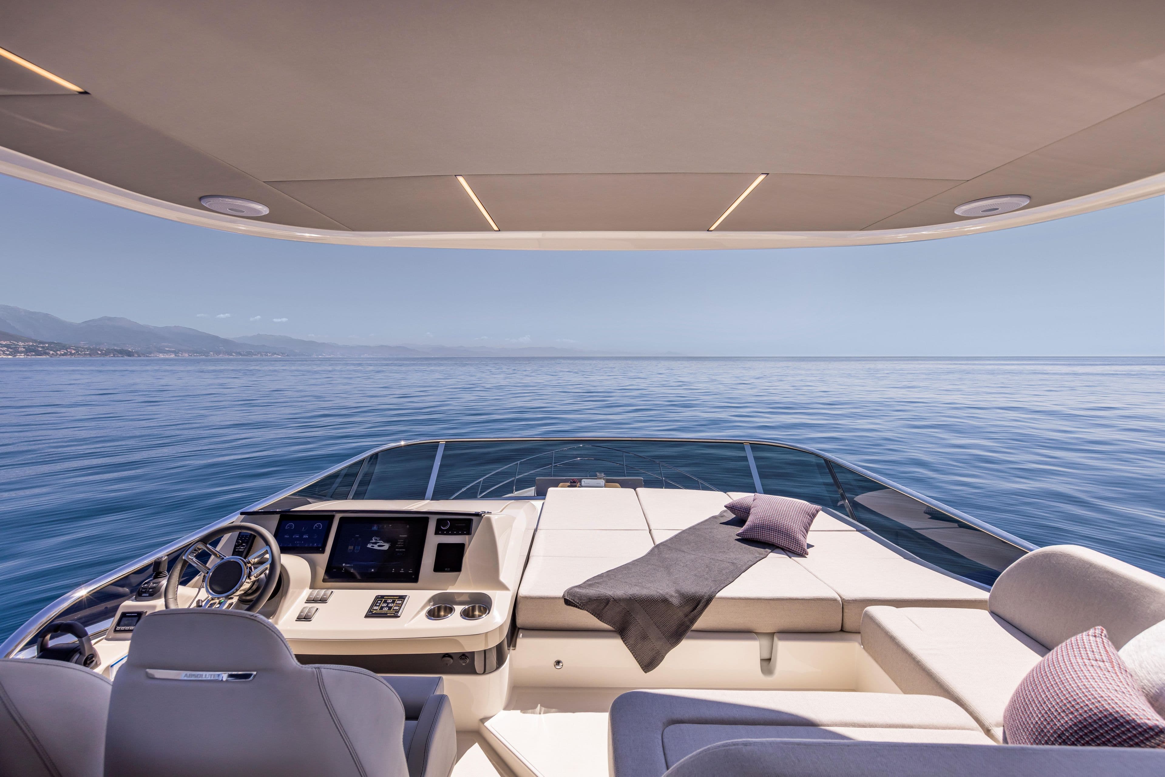 Luxurious 2025 Absolute 56 FLY yacht interior with ocean view and modern design.