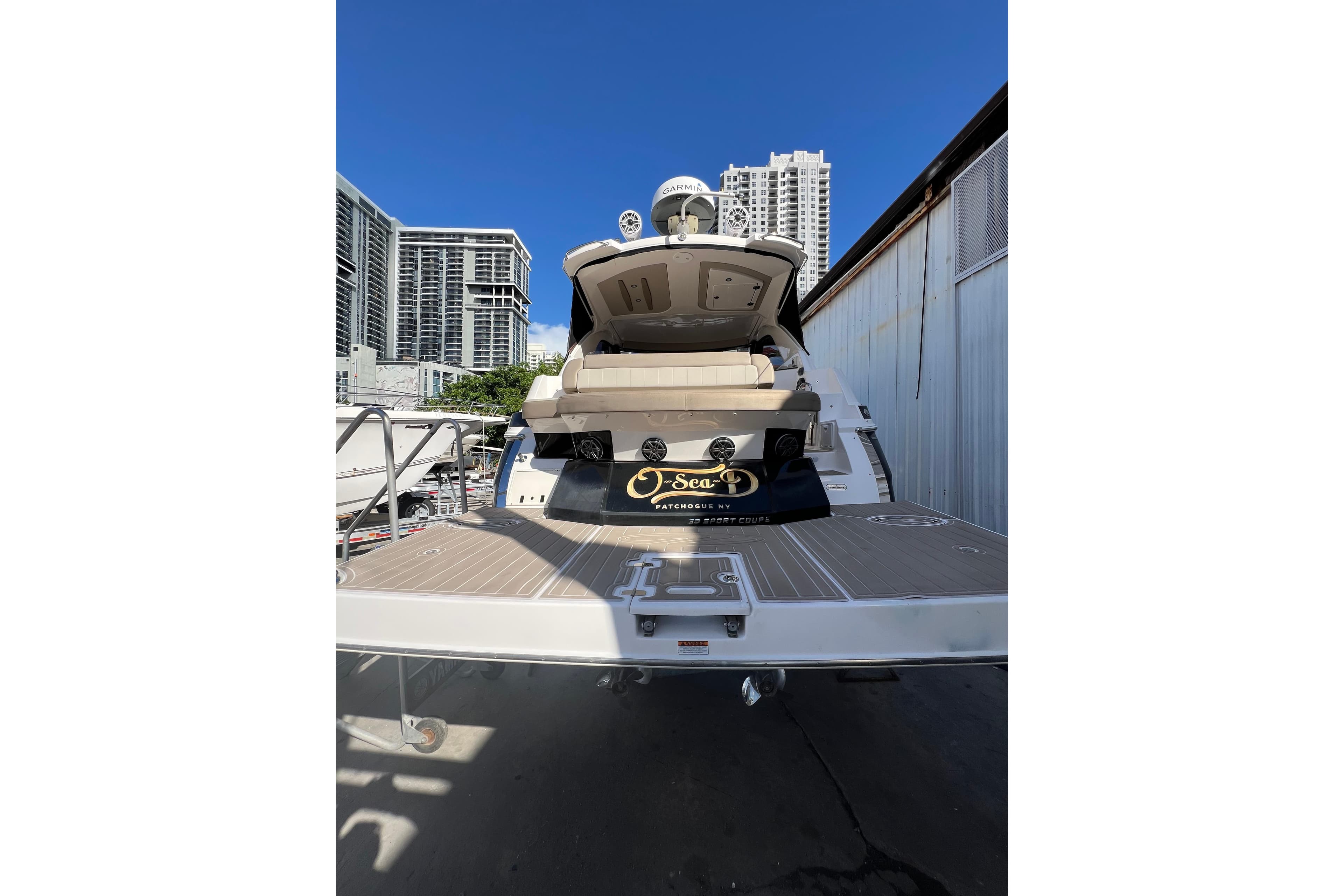 2015 Regal 35 Sport Coupe yacht docked with city skyline background.