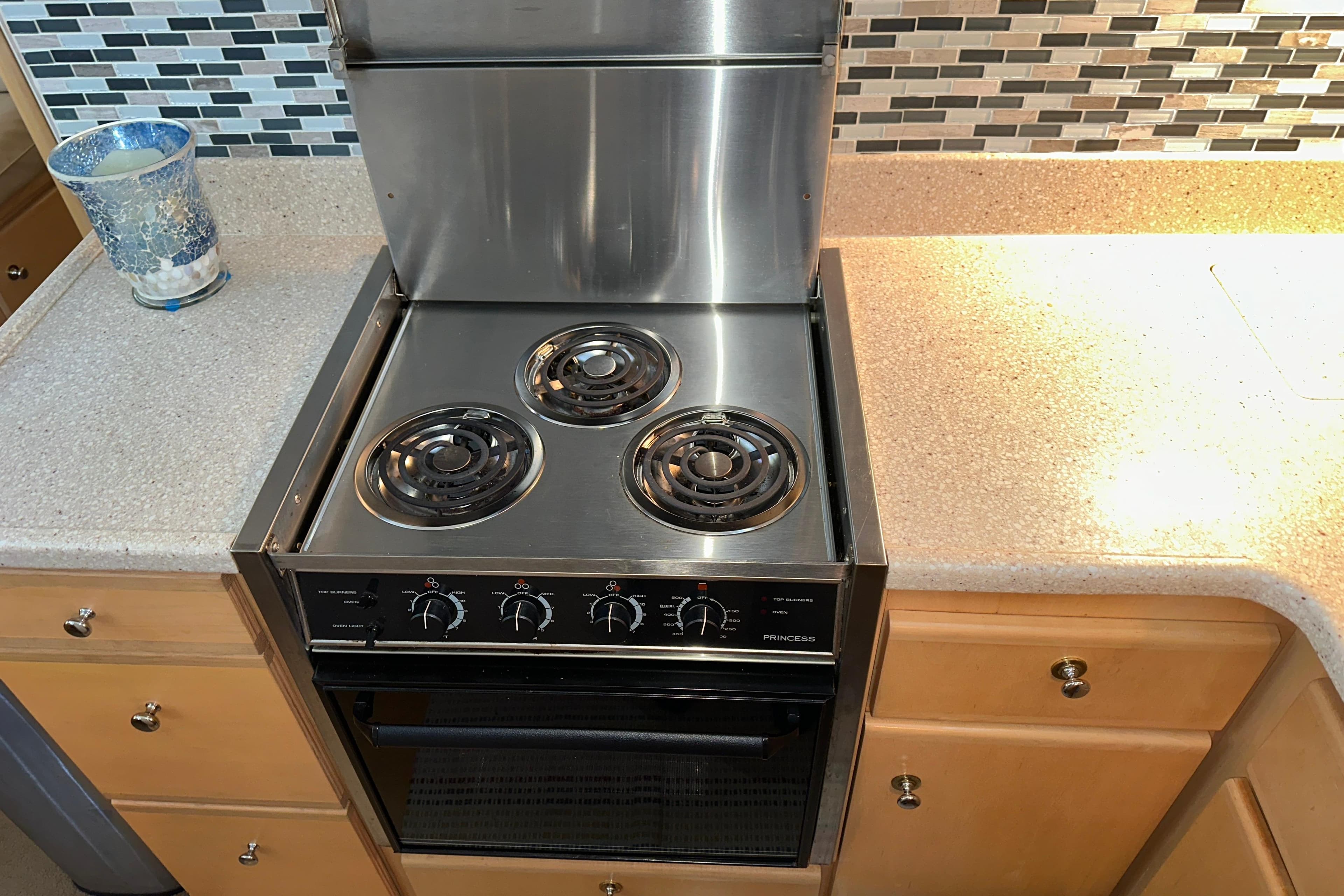 Stove in 1998 Carver 445 Aft Cabin Motor Yacht kitchen with backsplash and countertop.