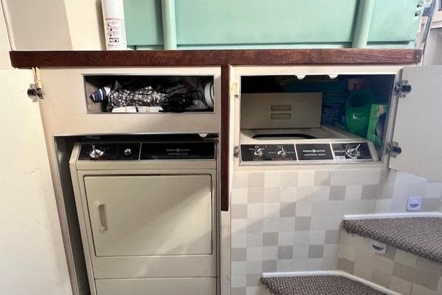Laundry area inside a 1989 Trojan 12 Meter Motor Yacht with appliances and storage.