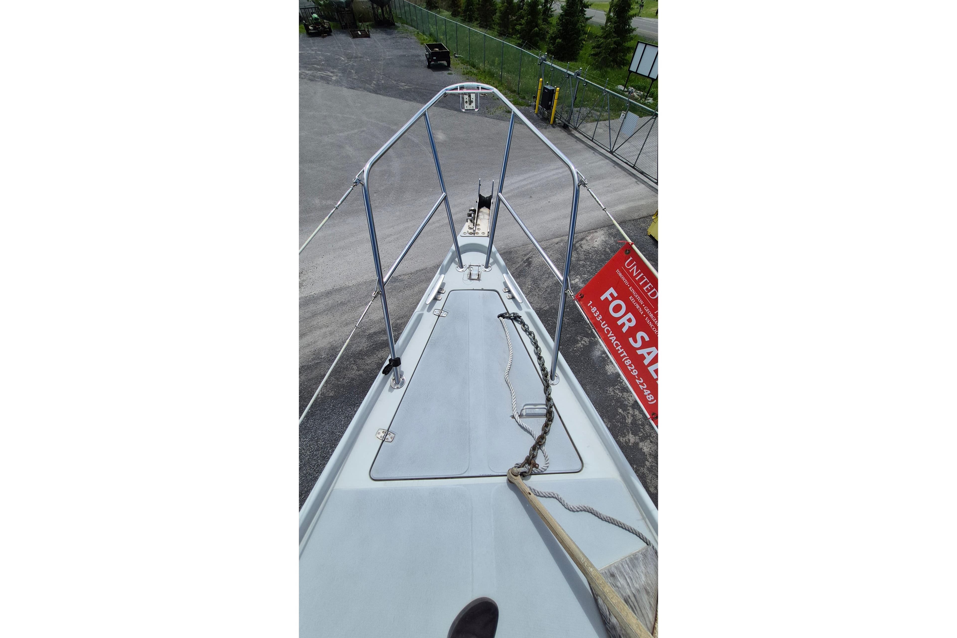 1991 Ericson 38 sailboat deck with railing, for sale sign visible.