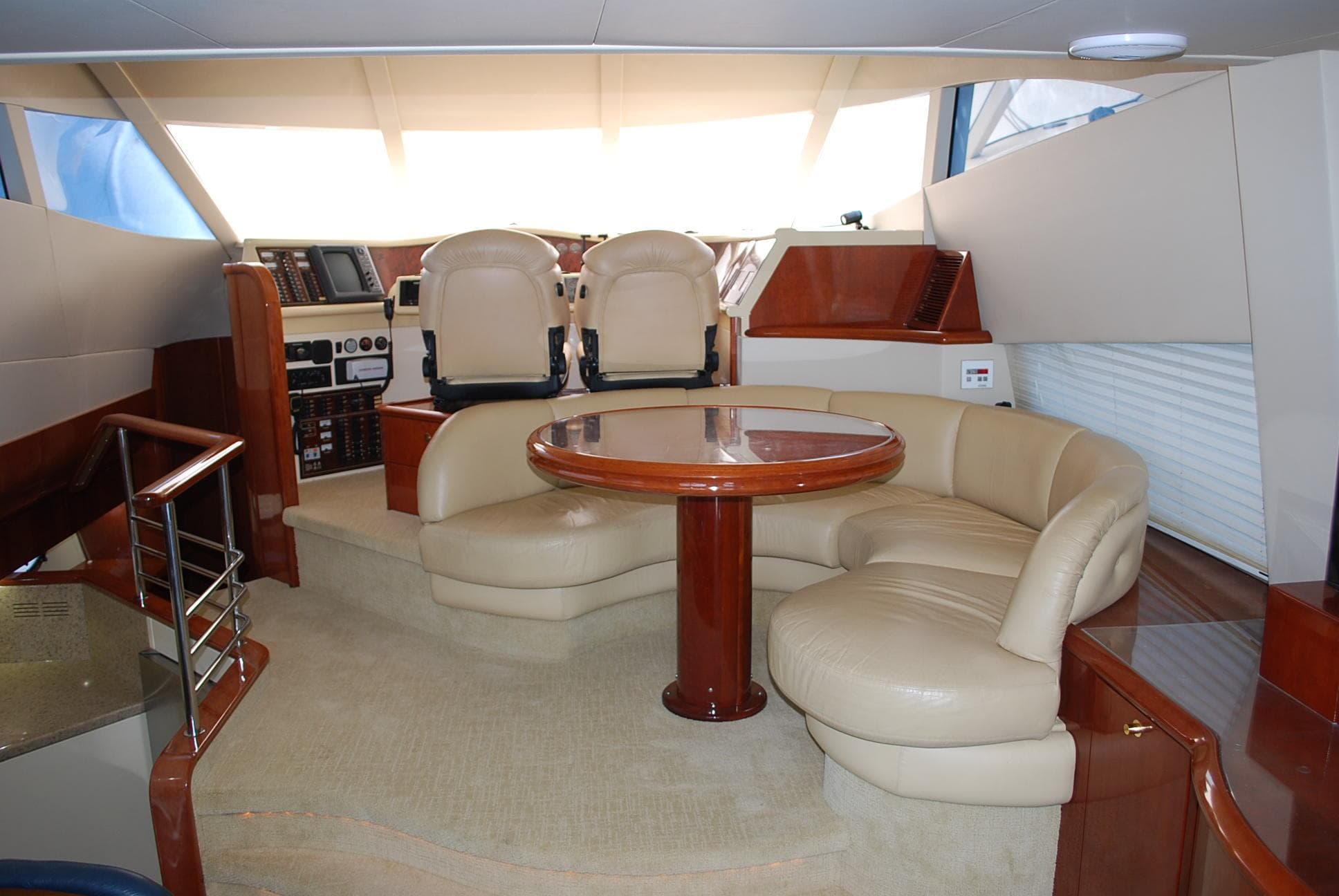 Luxurious interior of a 2000 Fairline Squadron yacht with plush seating and elegant wood finishes.