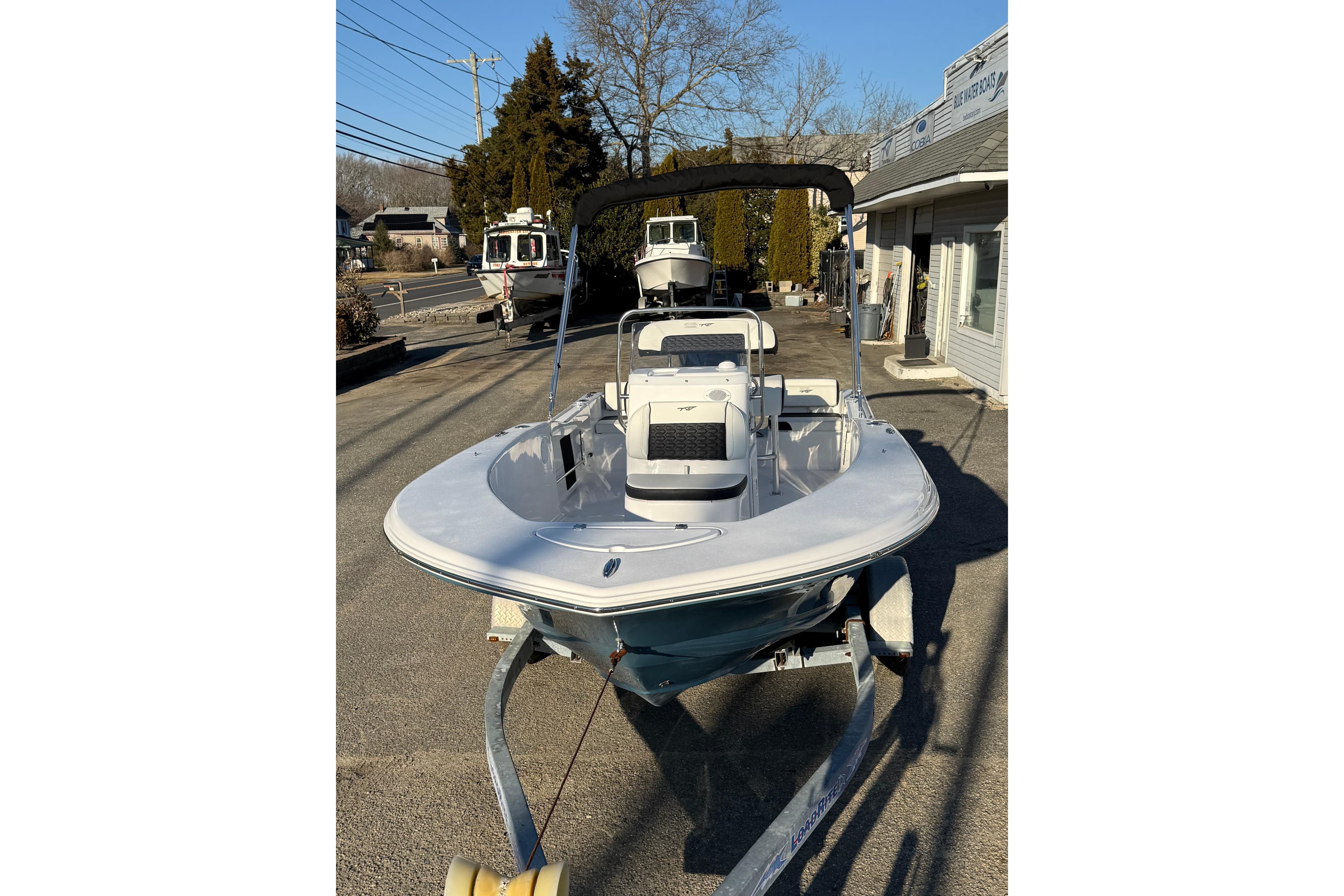 2026 Tidewater 180 CC Adventure boat on trailer, parked outdoors.
