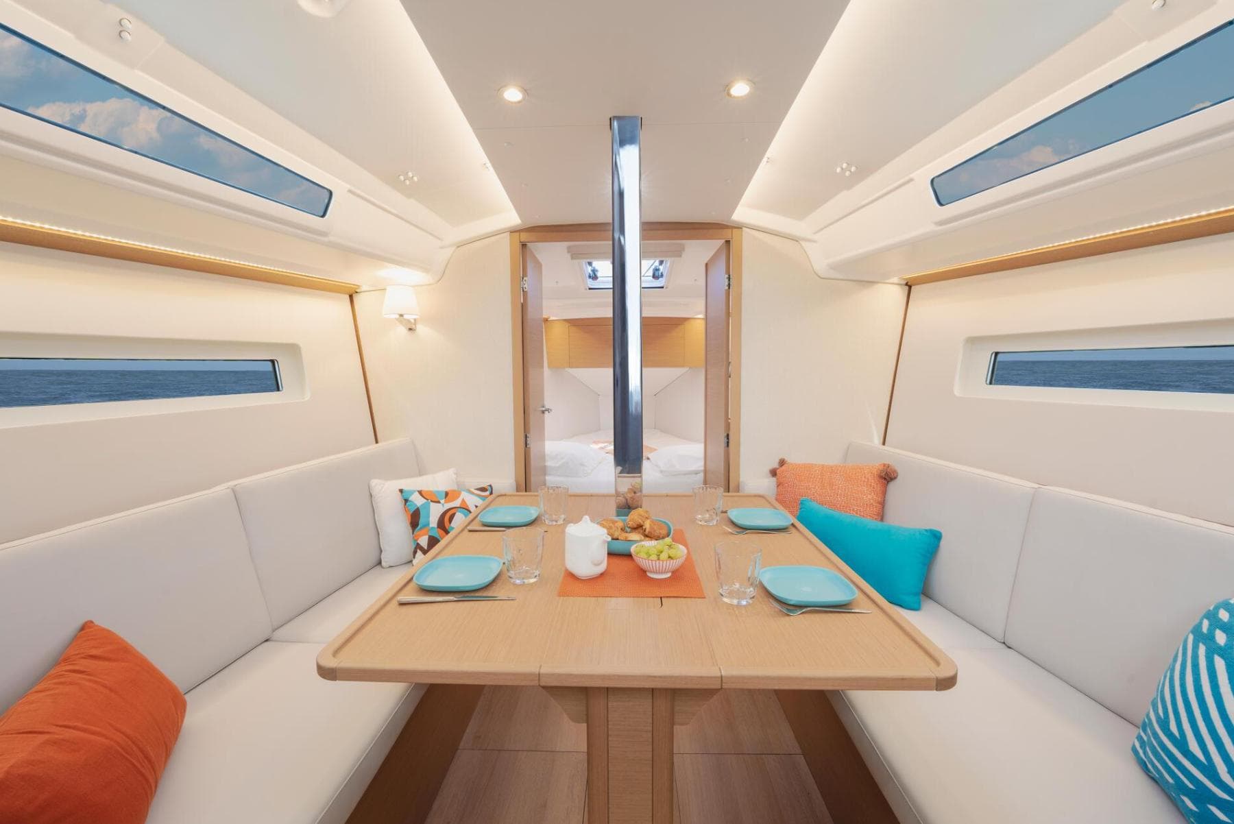 Interior of 2026 Jeanneau Sun Odyssey 350 yacht with elegant dining area and modern decor.