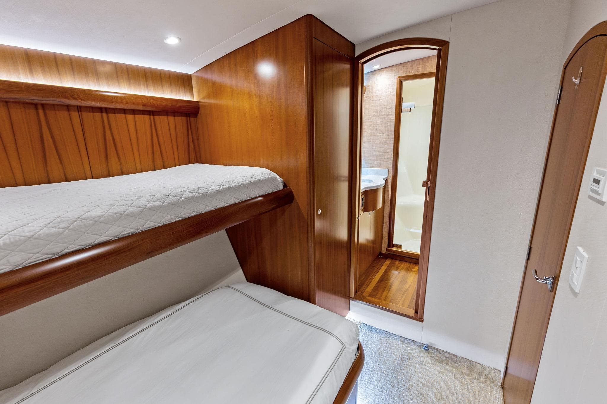 Luxurious 2017 Weaver Custom Sportfish cabin with bunk beds and ensuite bathroom.