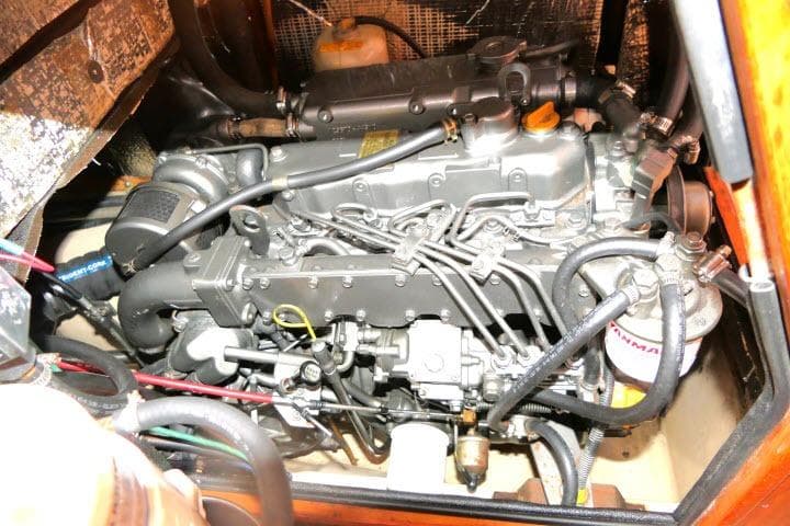 Engine compartment of a 1999 Island Packet 45 sailboat, showcasing detailed mechanical components.