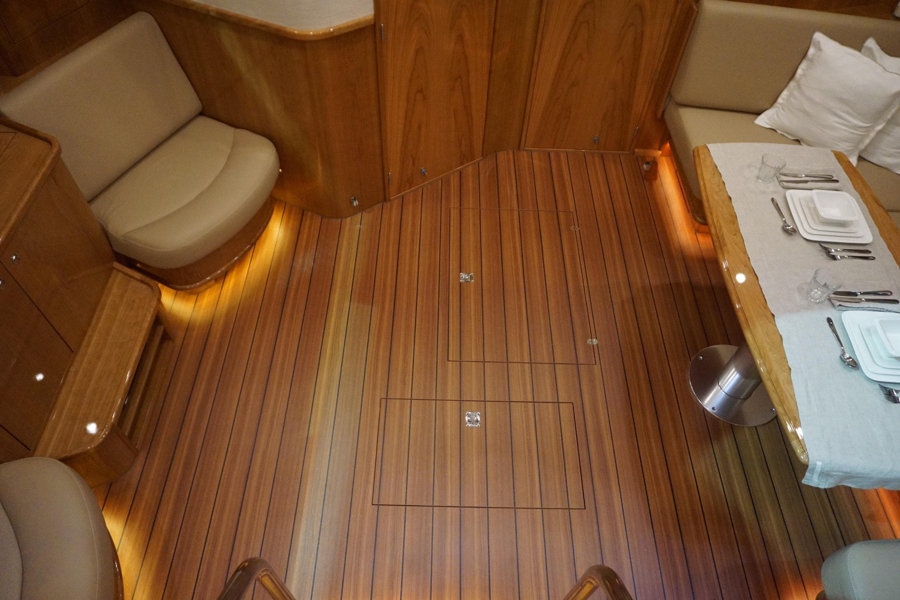 Luxurious interior of 2026 Elling E6 yacht with elegant wood flooring and dining area.