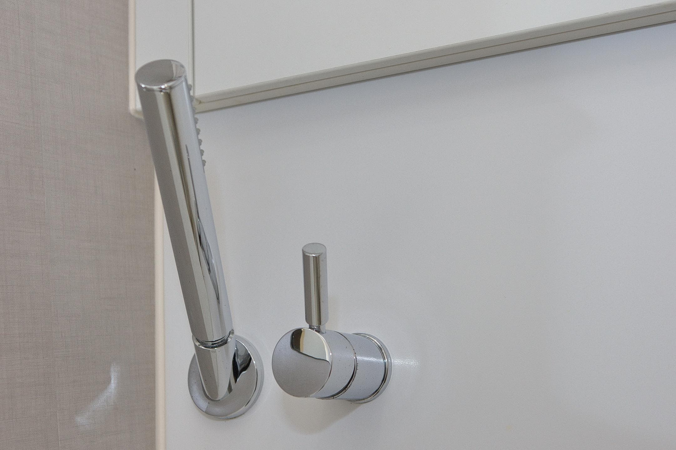Chrome shower handle and control in 2014 Greenline 48 Fly yacht bathroom.
