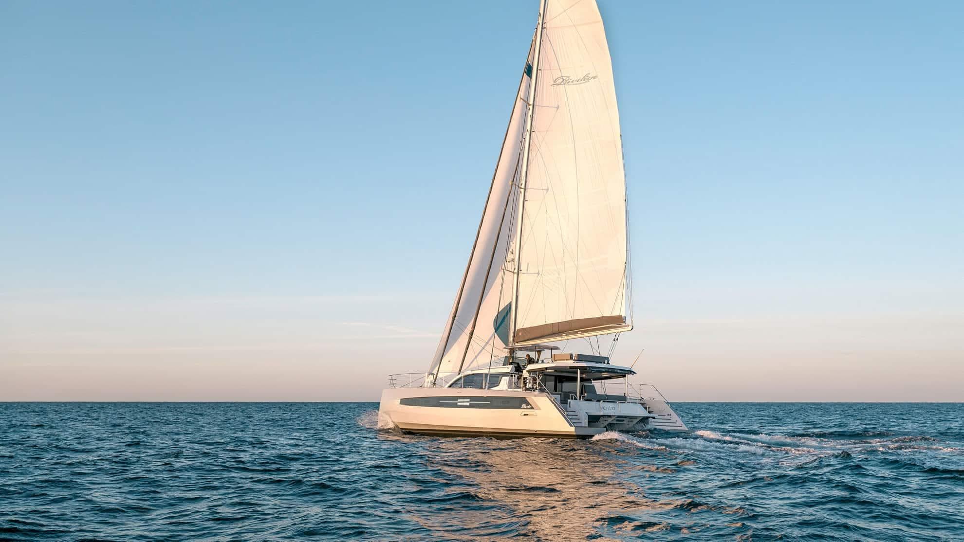 Luxury Privilege Signature 580 catamaran sailing on open sea, 2025 model.