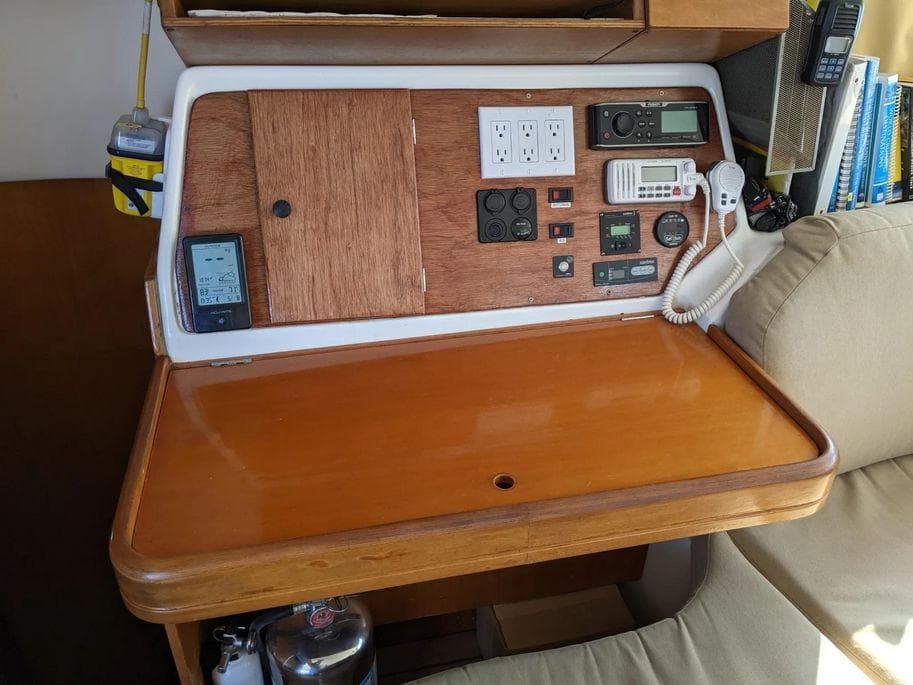 Navigation station on 1997 Lagoon 410 catamaran with control panel and communication devices.