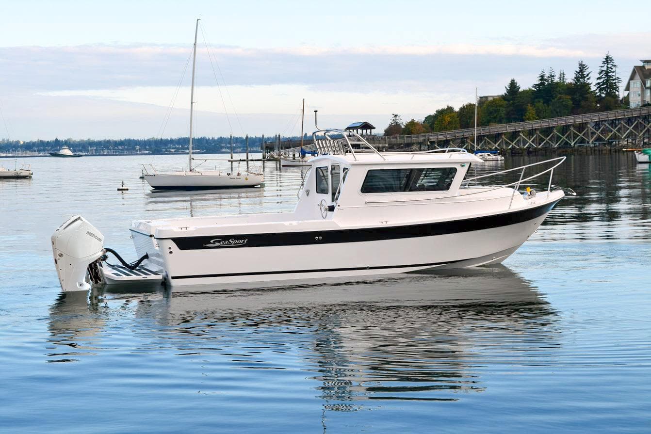 2026 Sea Sport Kenai 2600 boat on calm water, with scenic background.