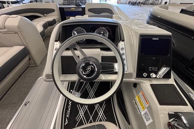 2026 Barletta Corsa 23UC boat dashboard with steering wheel and control panel.