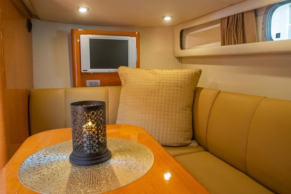 2007 Chaparral Signature 310 interior with cozy seating, candle, and TV.