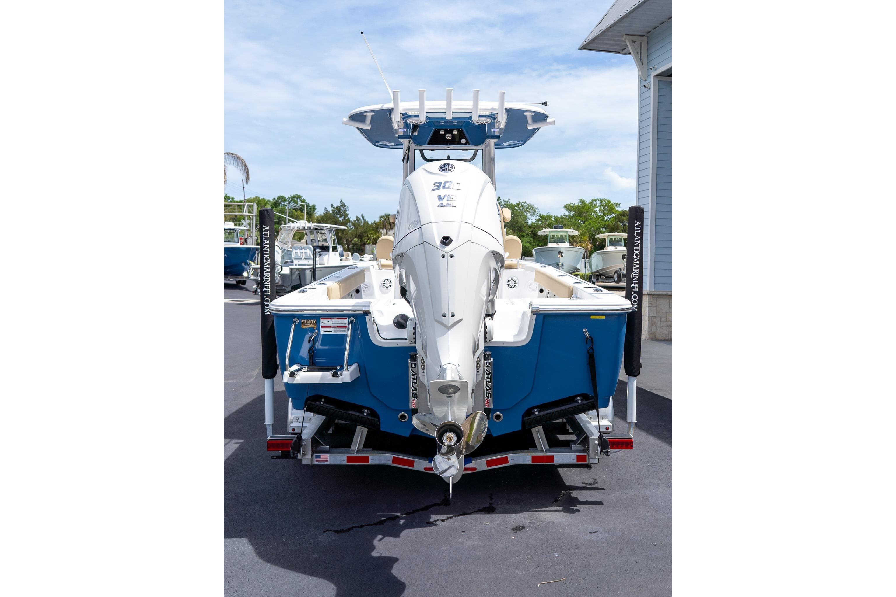 2026 Sportsman Masters 247 Bay Boat with Suzuki engine, parked on a trailer.