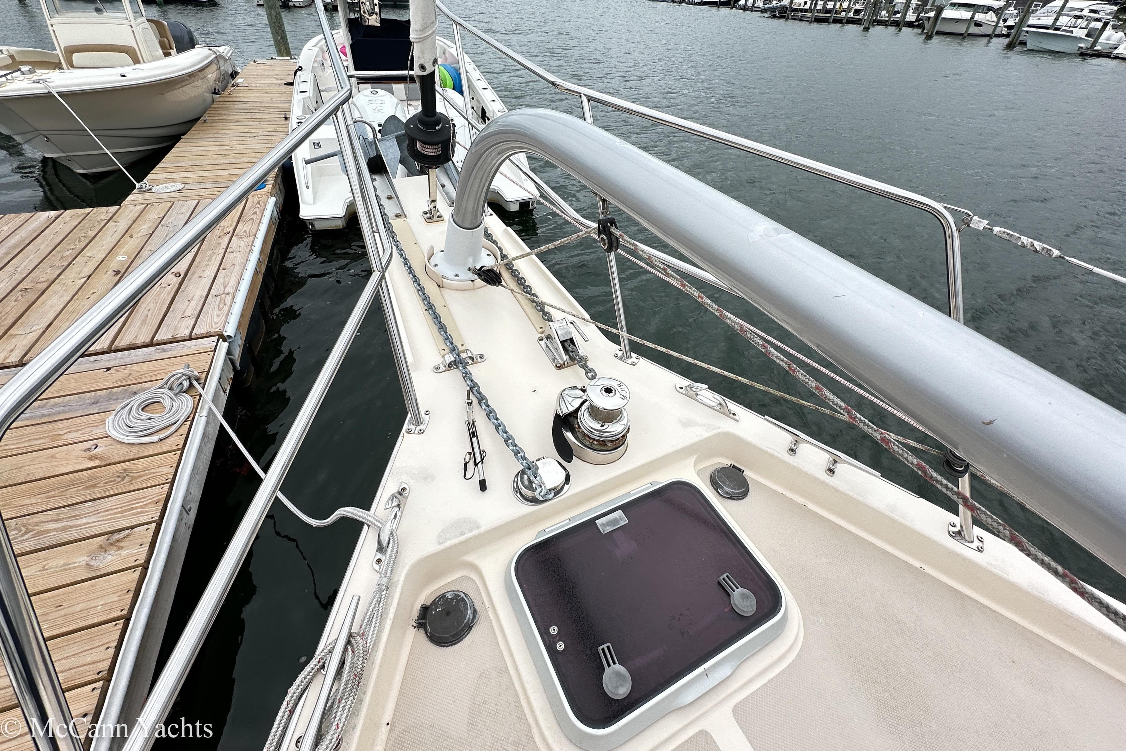 2010 Island Packet Estero sailboat deck at marina, featuring winch and hatch.