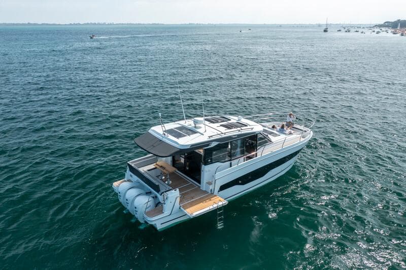 2025 Jeanneau NC 1295 Coupe yacht cruising on open water.