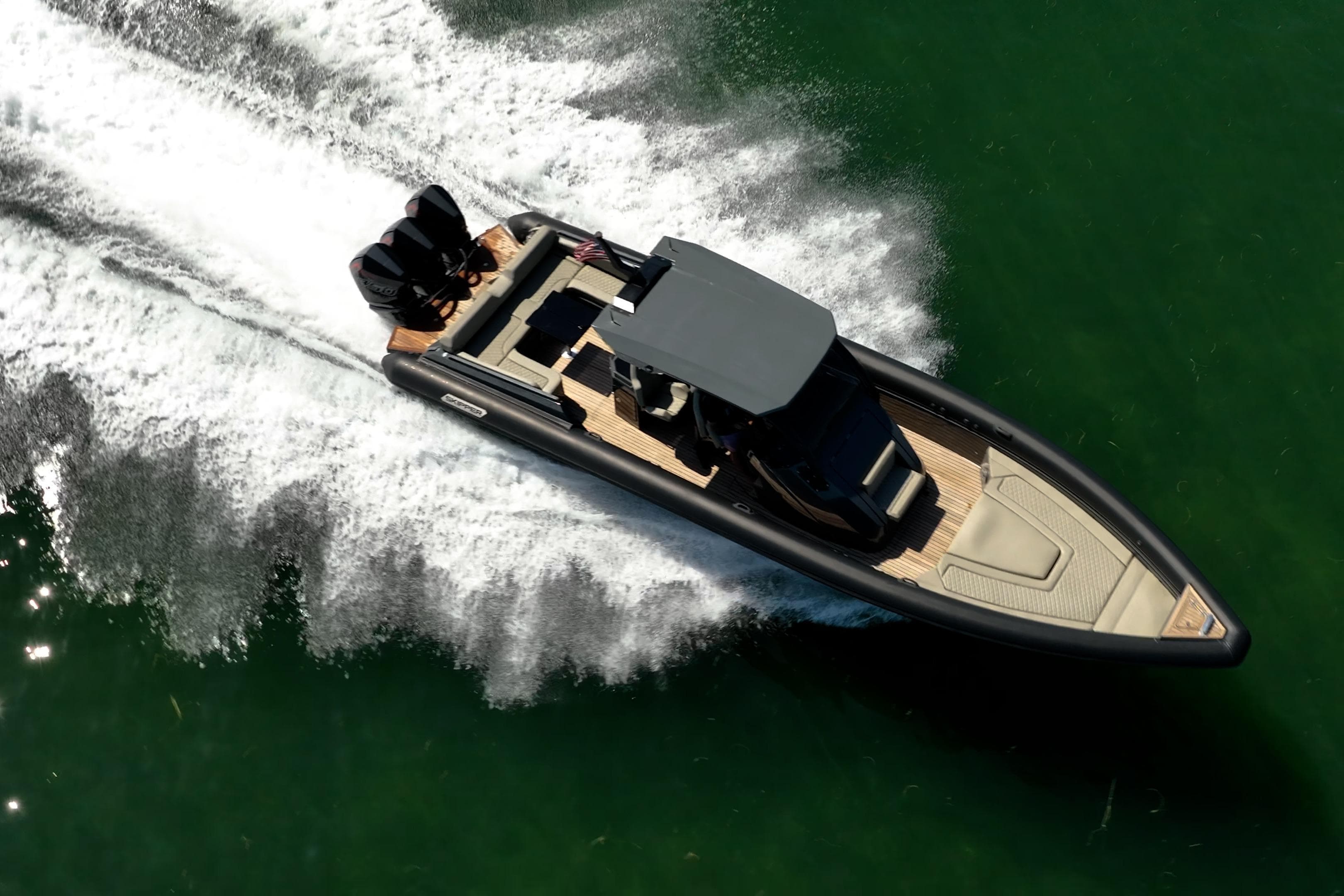 Aerial view of 2023 Skipper-BSK 38NC speedboat cruising on water.