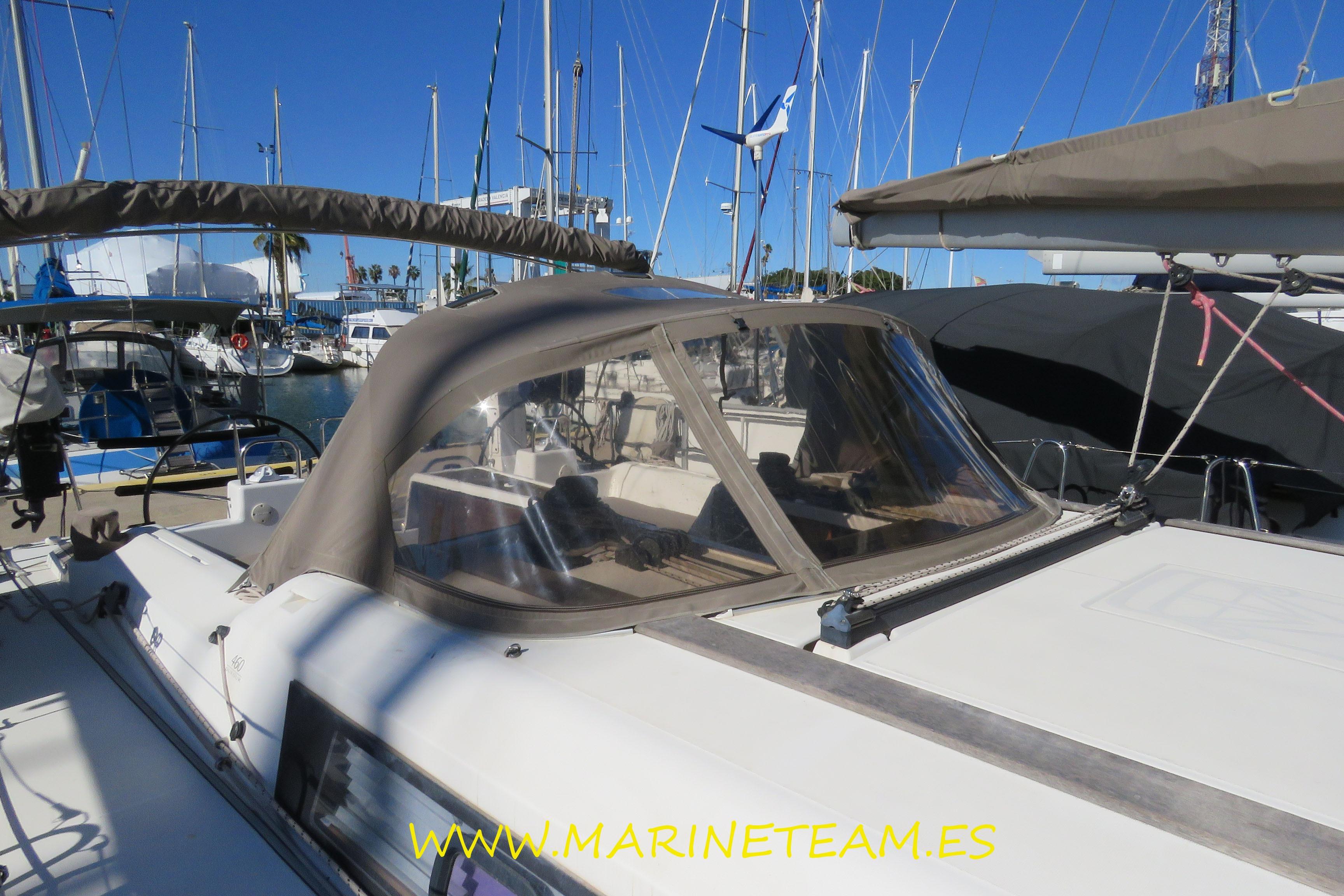 2017 Dufour 460 Grand Large yacht docked at marina under clear blue sky.