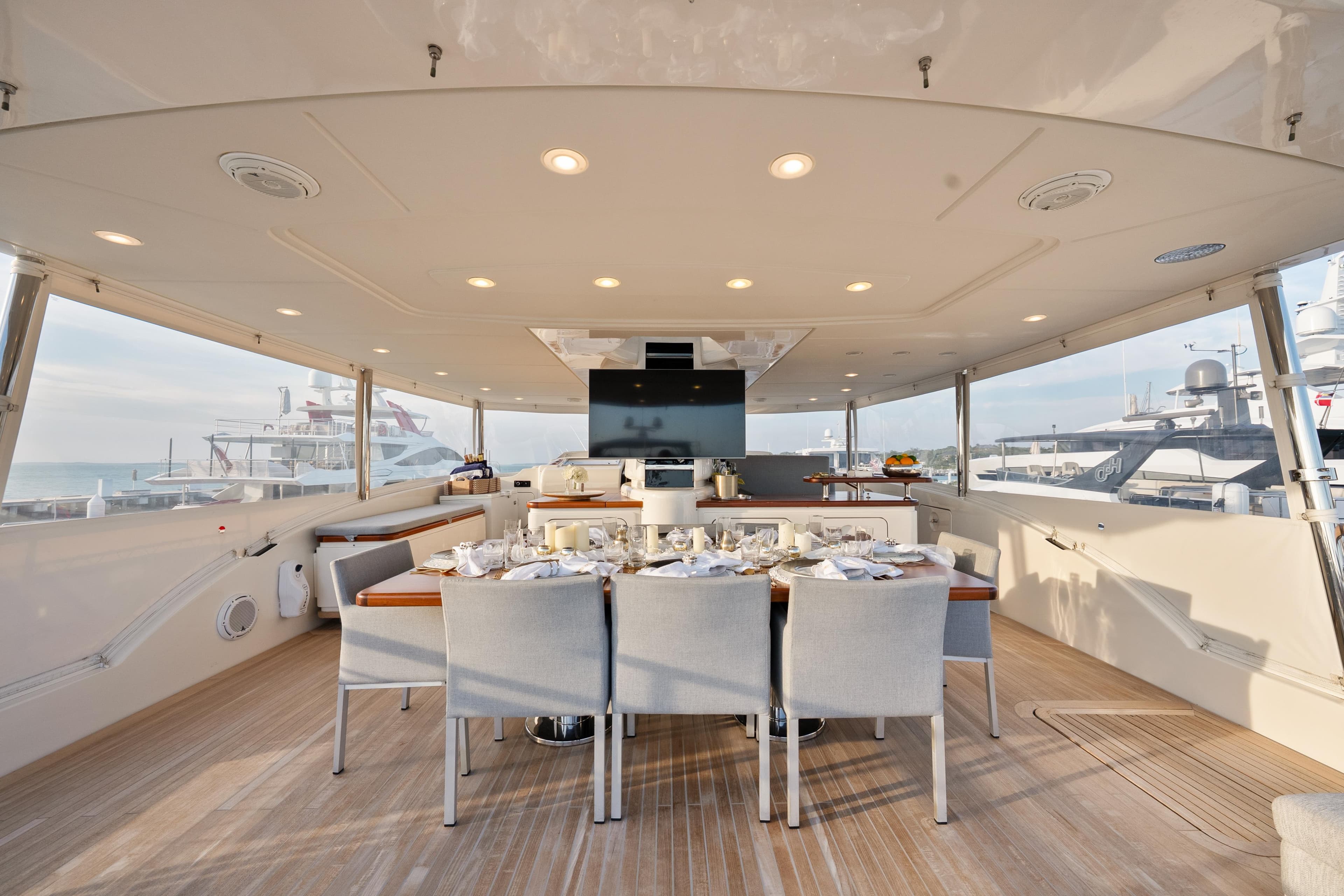 Luxurious dining area on 2012 Sanlorenzo SD92 yacht, featuring elegant table setting and modern design.
