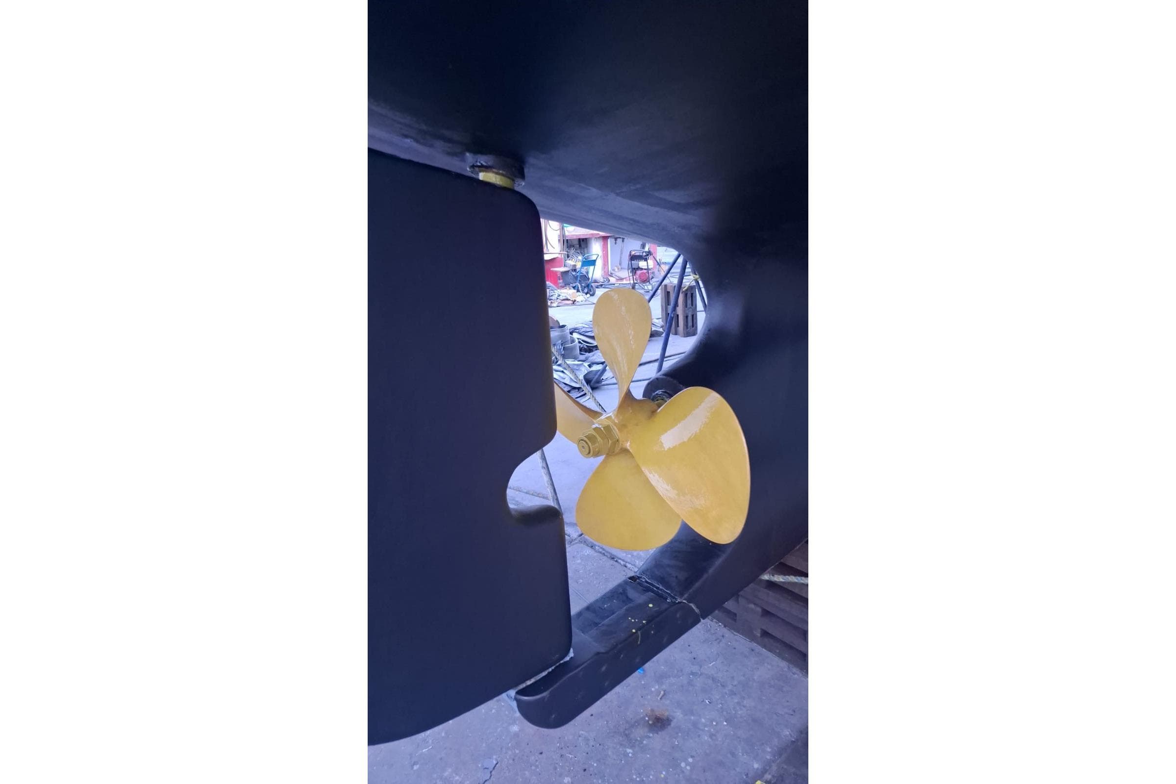 Yellow propeller of a 2003 Nordhavn 46 boat, close-up view.