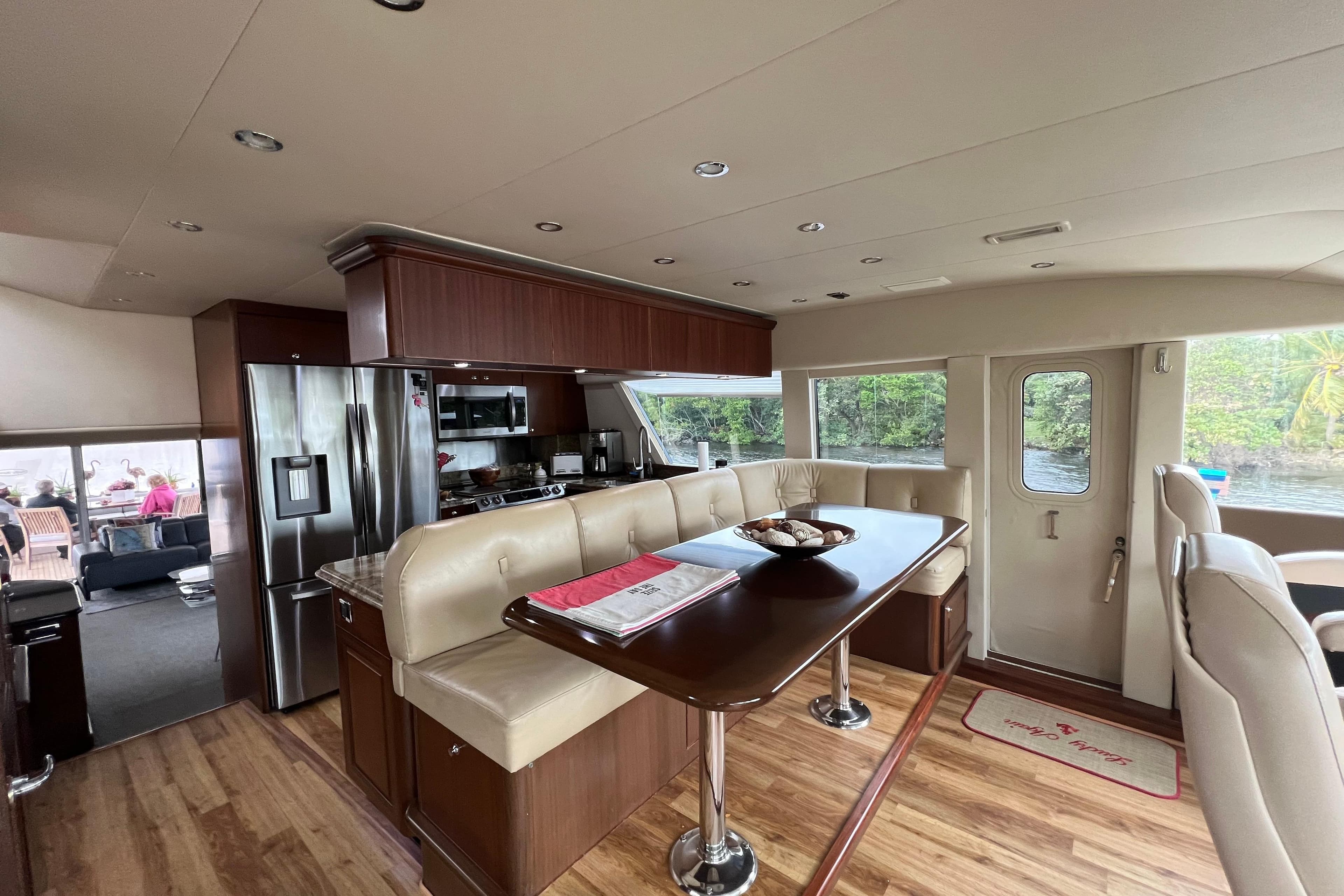 Luxurious interior of 2006 Pacific Mariner 85 yacht with modern kitchen and dining area.