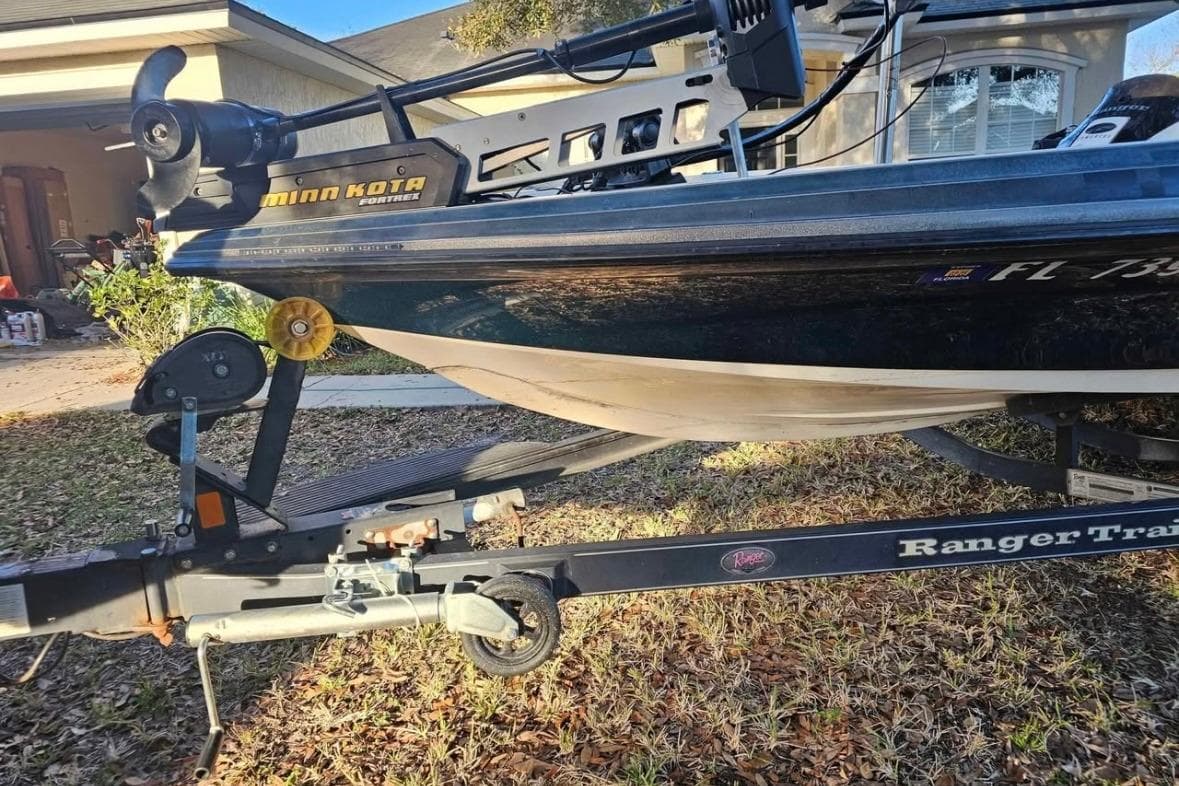 2008 Ranger Z520 Comanche boat on trailer, featuring Minn Kota motor, parked in driveway.