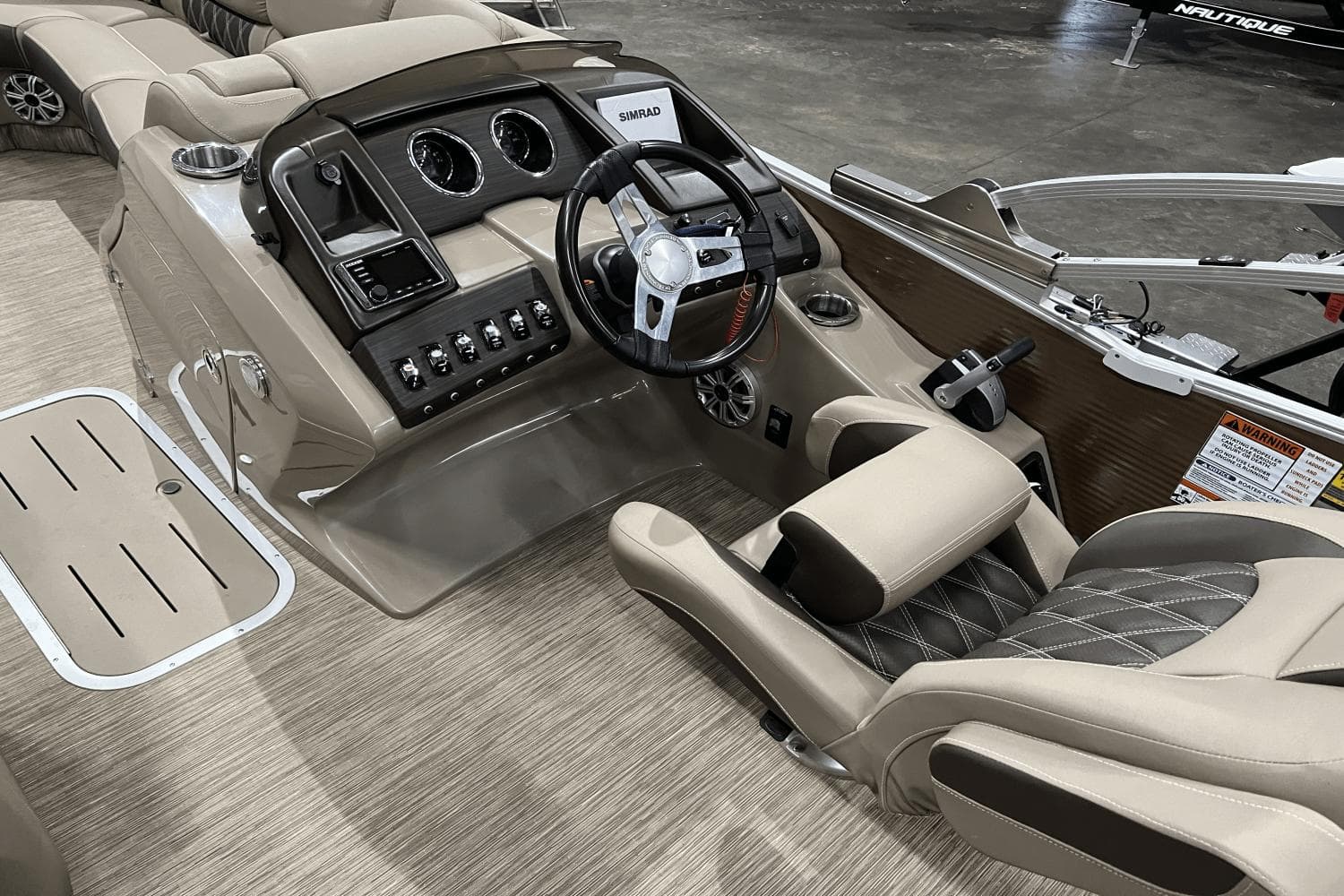 2019 Bennington 23RSBDN boat interior with steering console and luxurious seating.