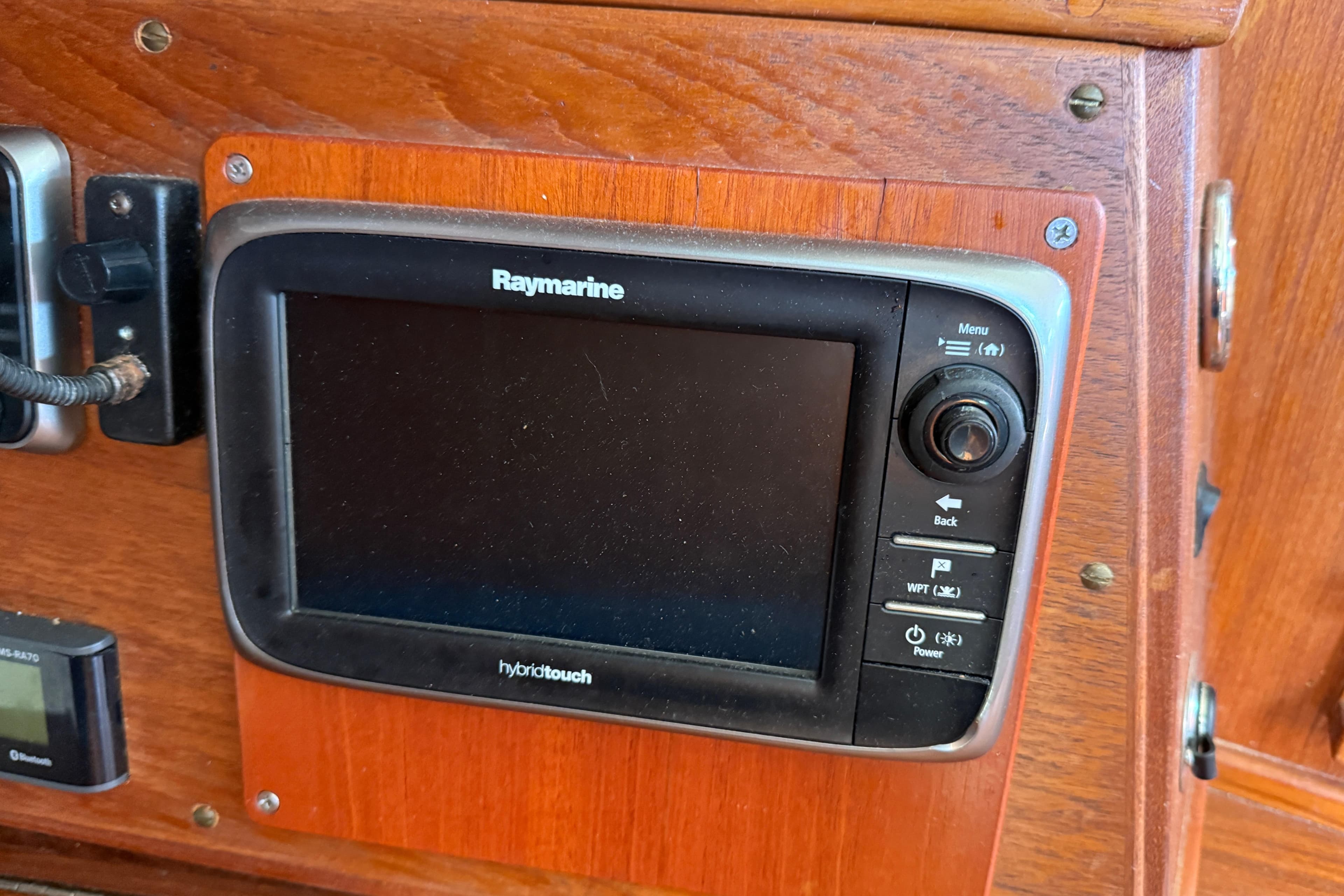 Raymarine display on 1997 Tartan 3800 sailboat, mounted on wooden panel.