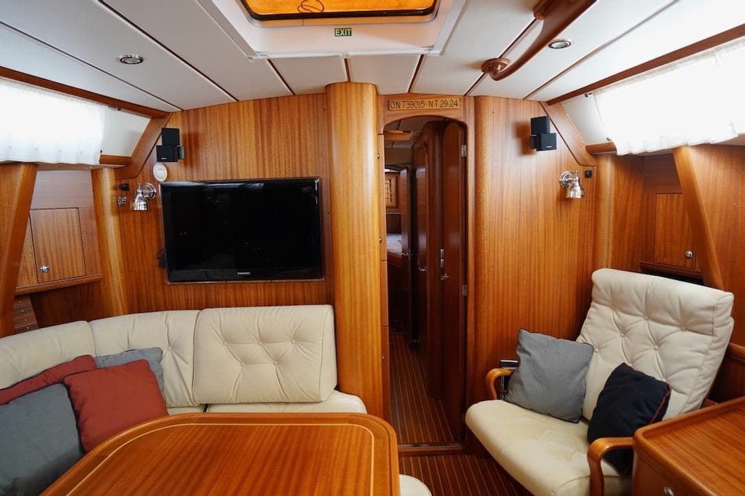 Luxurious interior of 2010 Najad 511 yacht with wood paneling and comfortable seating.