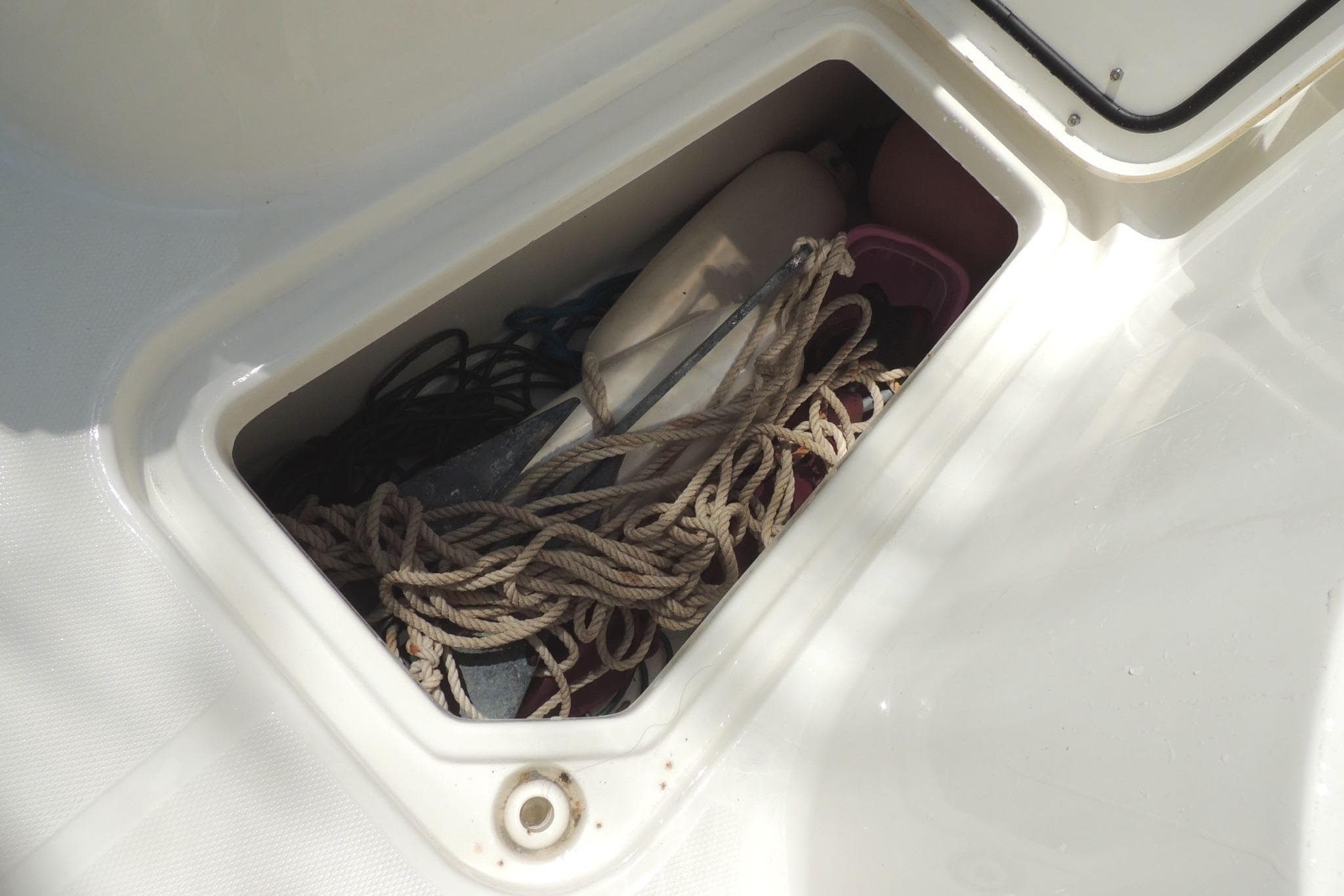 Storage compartment on a 2020 Sea Hunt Gamefish 27, containing ropes and boating gear.