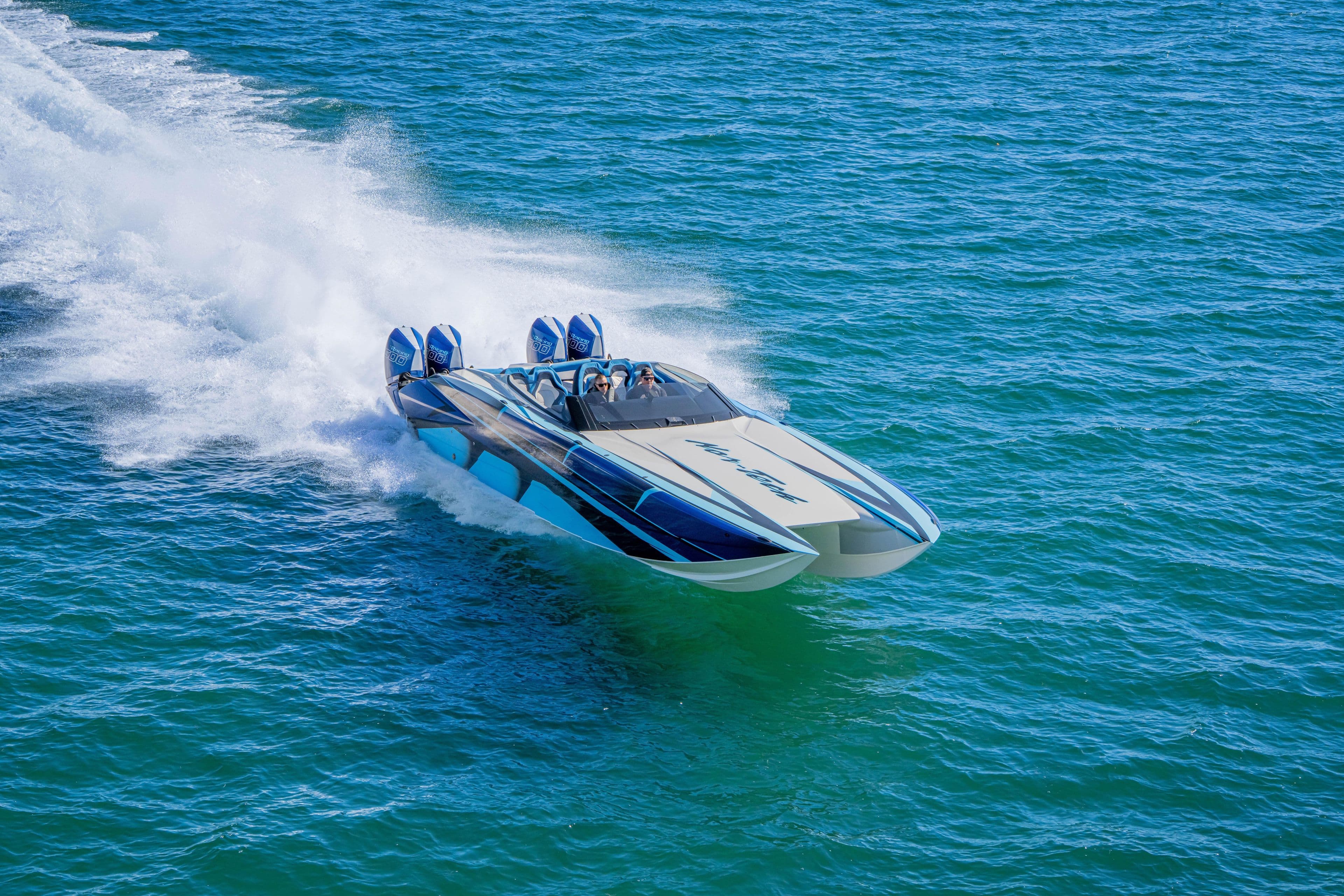 2026 Nor-Tech 4000 Super Catamaran speeding on open water, showcasing sleek design and power.