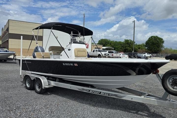2016 Sportmans Masters 227 Bay Boat on trailer, parked outdoors under cloudy sky.