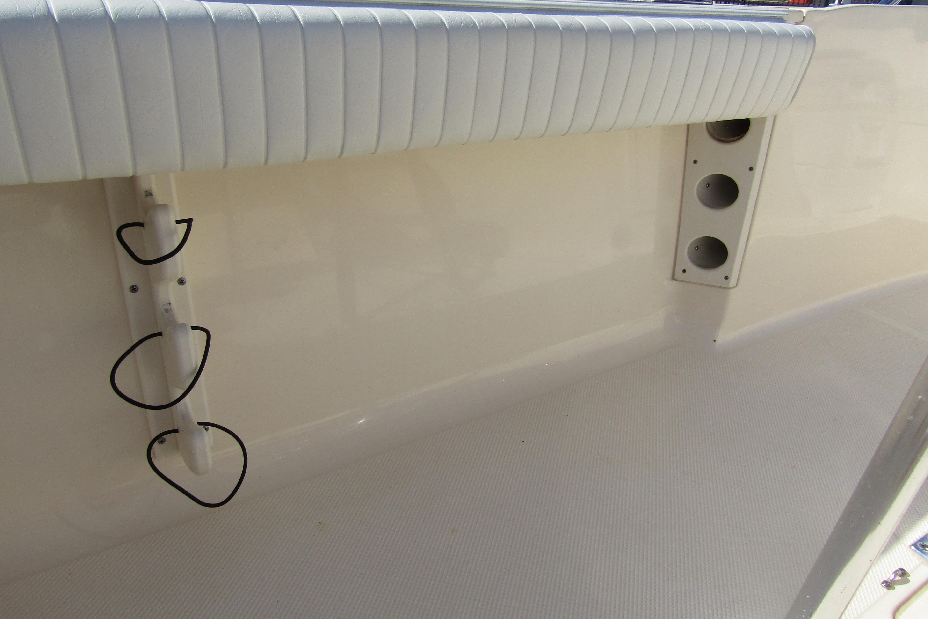 Interior of 2004 Key West Center Console boat with rod holders and cushioned seating.
