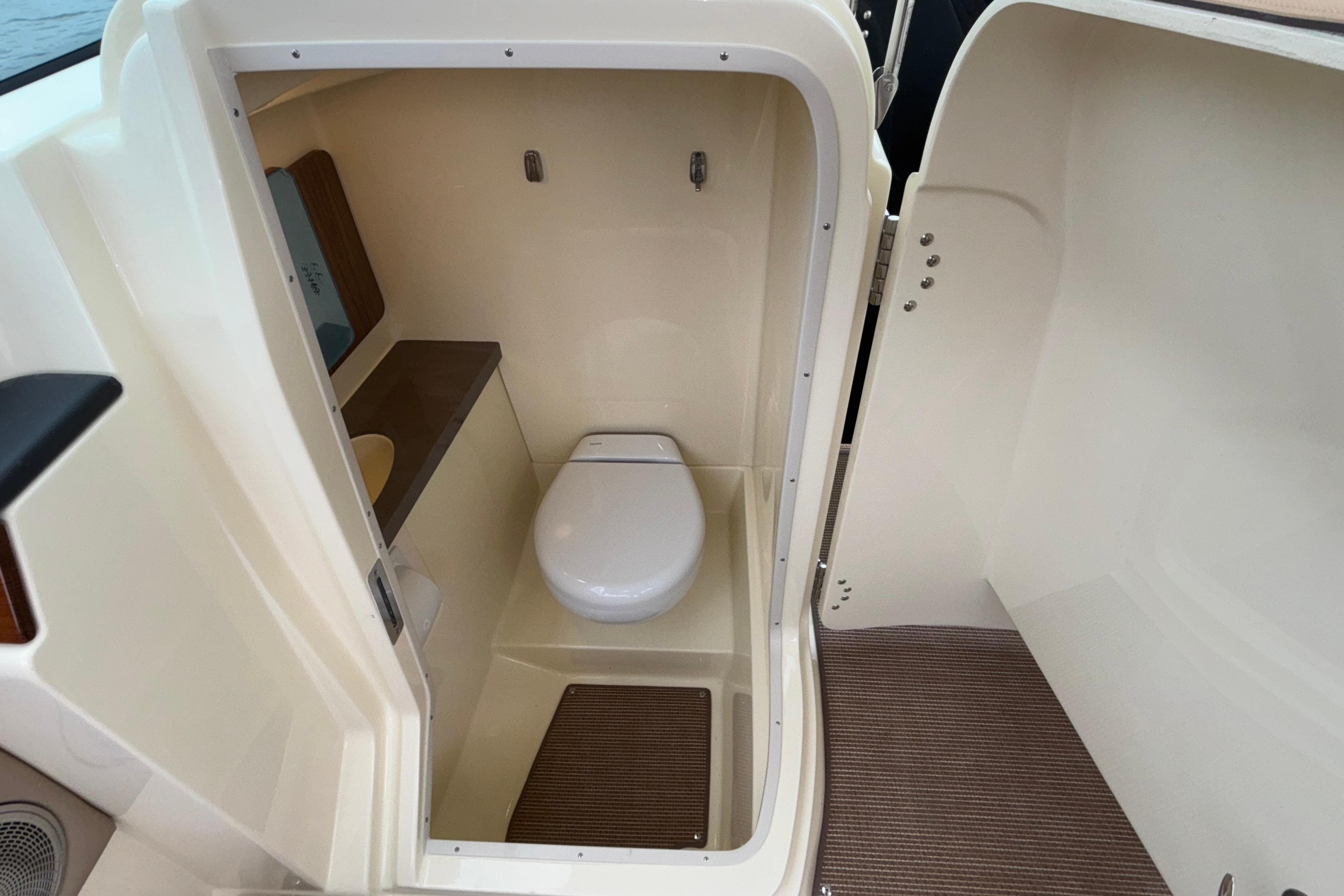 2026 Chris-Craft Calypso 28 boat interior bathroom with toilet and compact design.