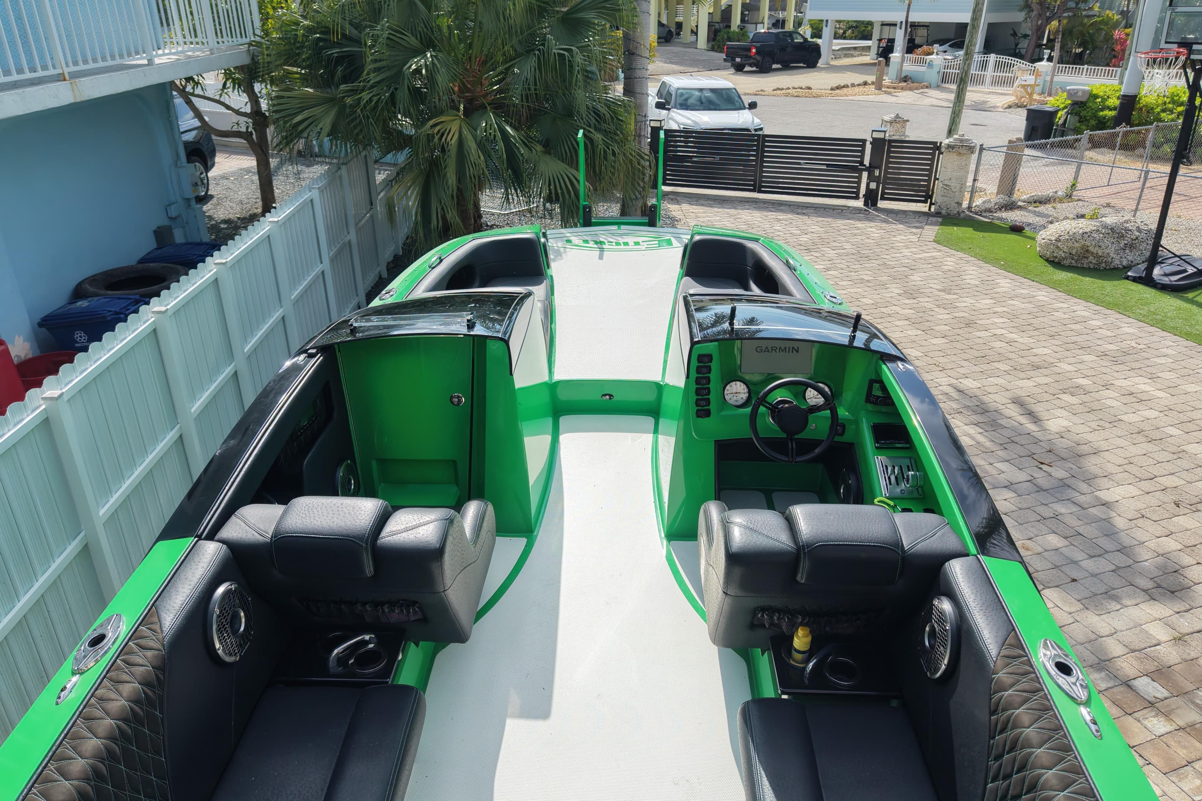 2021 E-Ticket 29 boat with green and black interior, parked in a driveway.