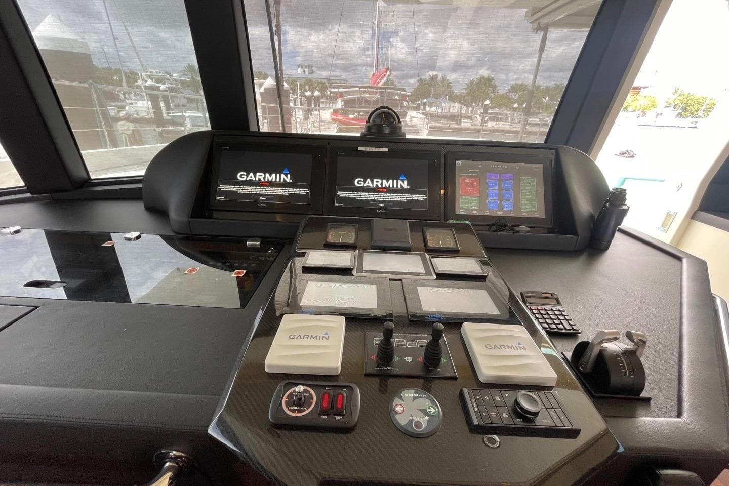 Cockpit of 2018 Serenity 64 yacht with Garmin navigation displays and control panels.