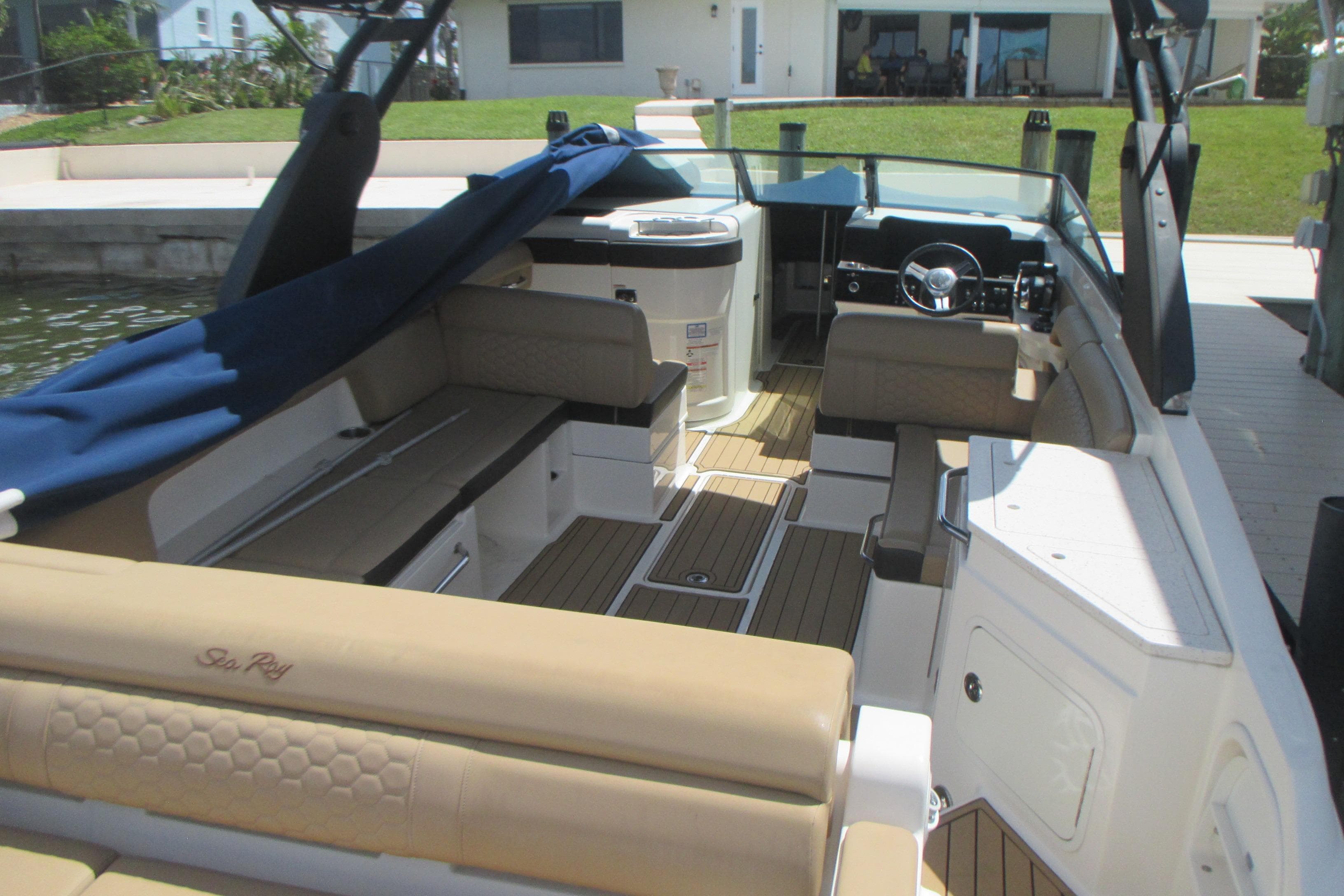 2019 Sea Ray 290 SLX boat interior with tan seating and wooden flooring.